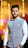 A man standing in a room with lights in the background