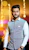 A man standing in a room with lights in the background