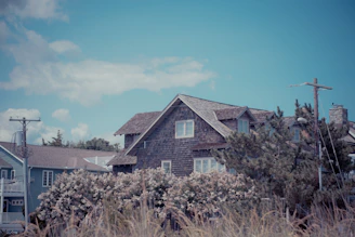 A house in the middle of a field of tall grass