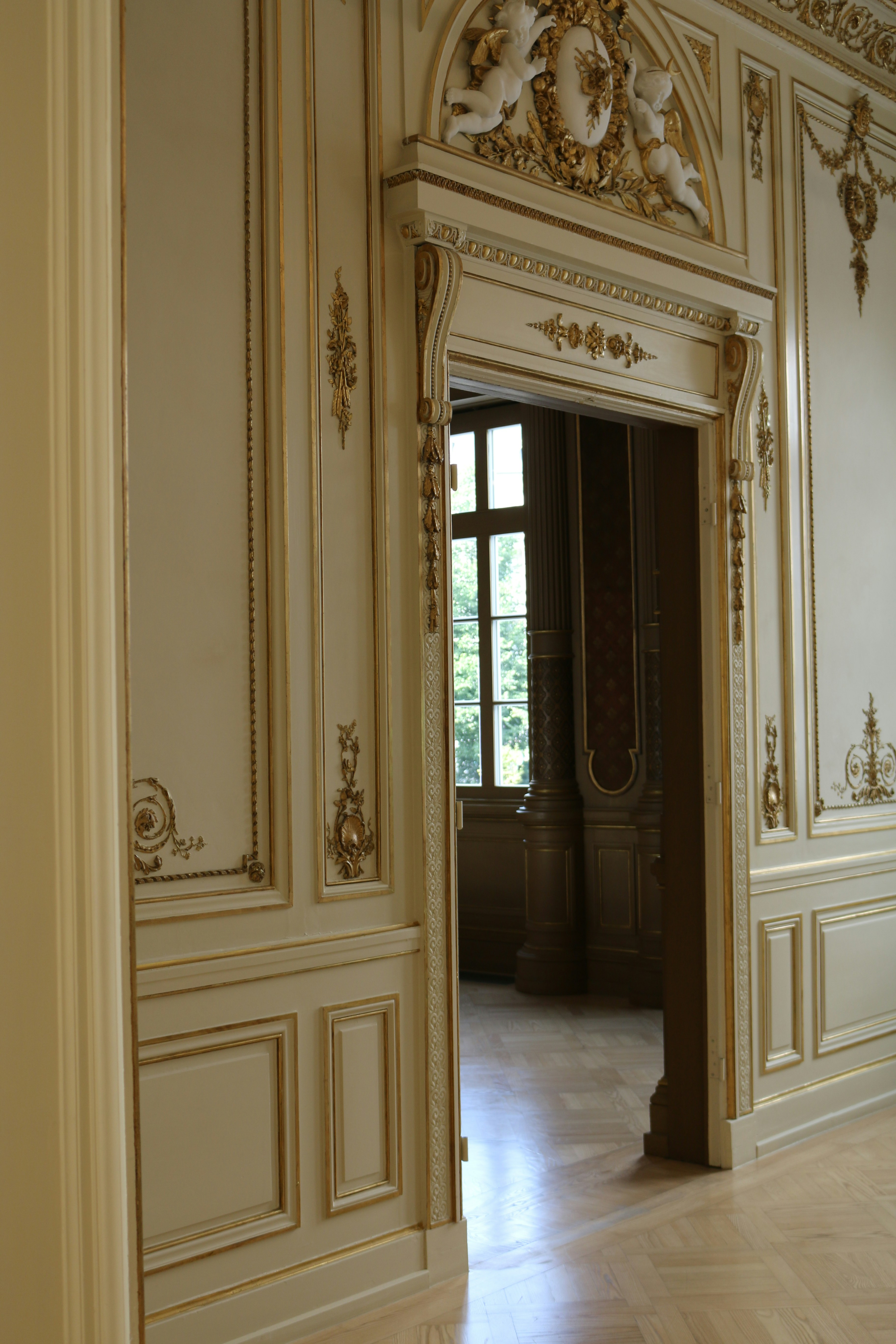 A large room with a doorway and a clock on the wall
