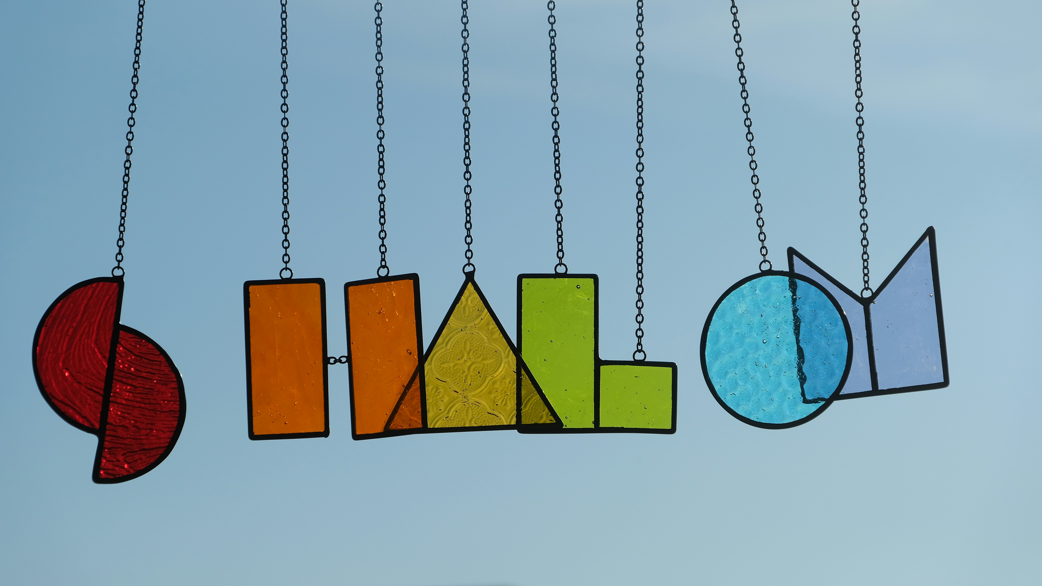 A group of colorful objects hanging from strings