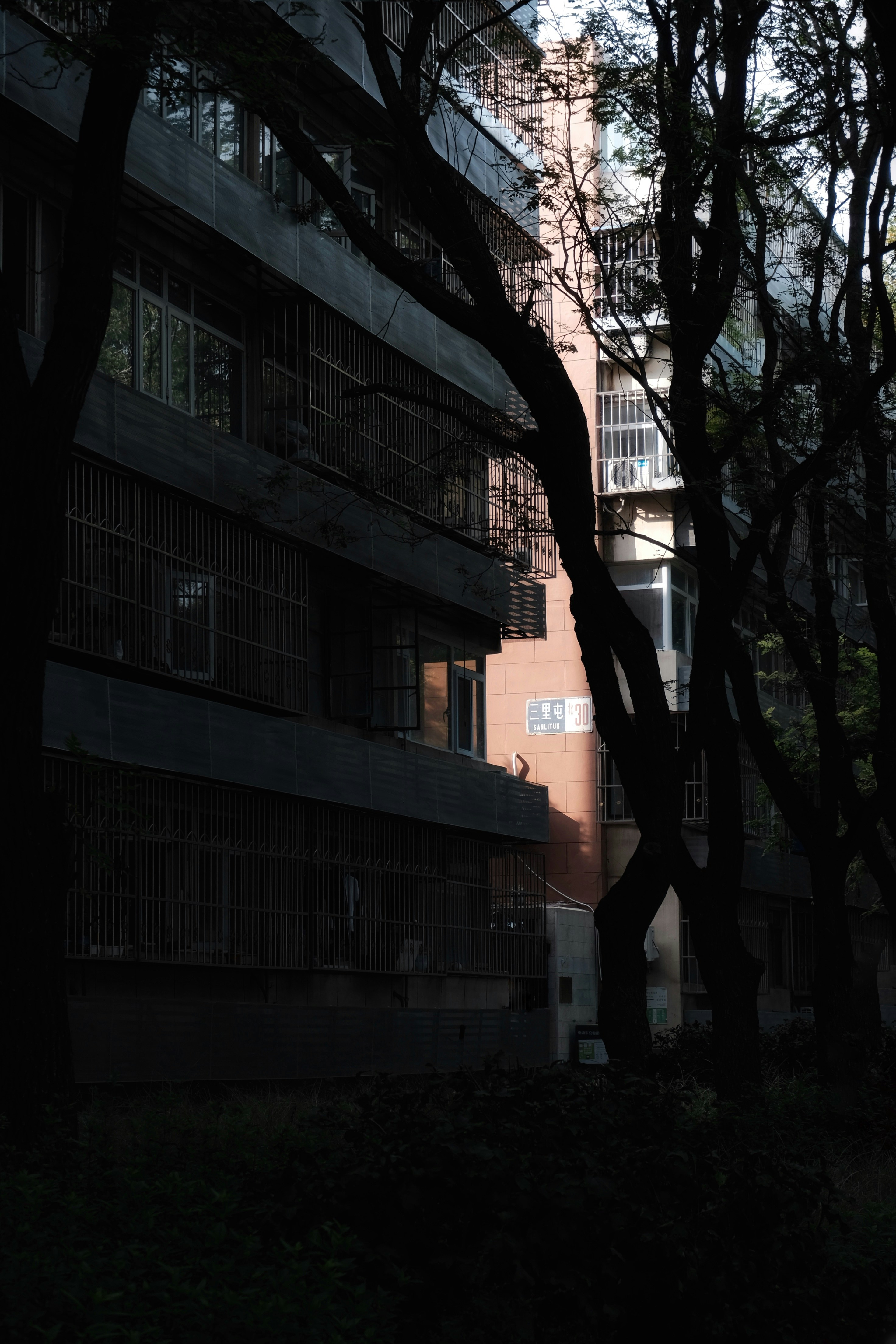 A tall building sitting next to a forest of trees