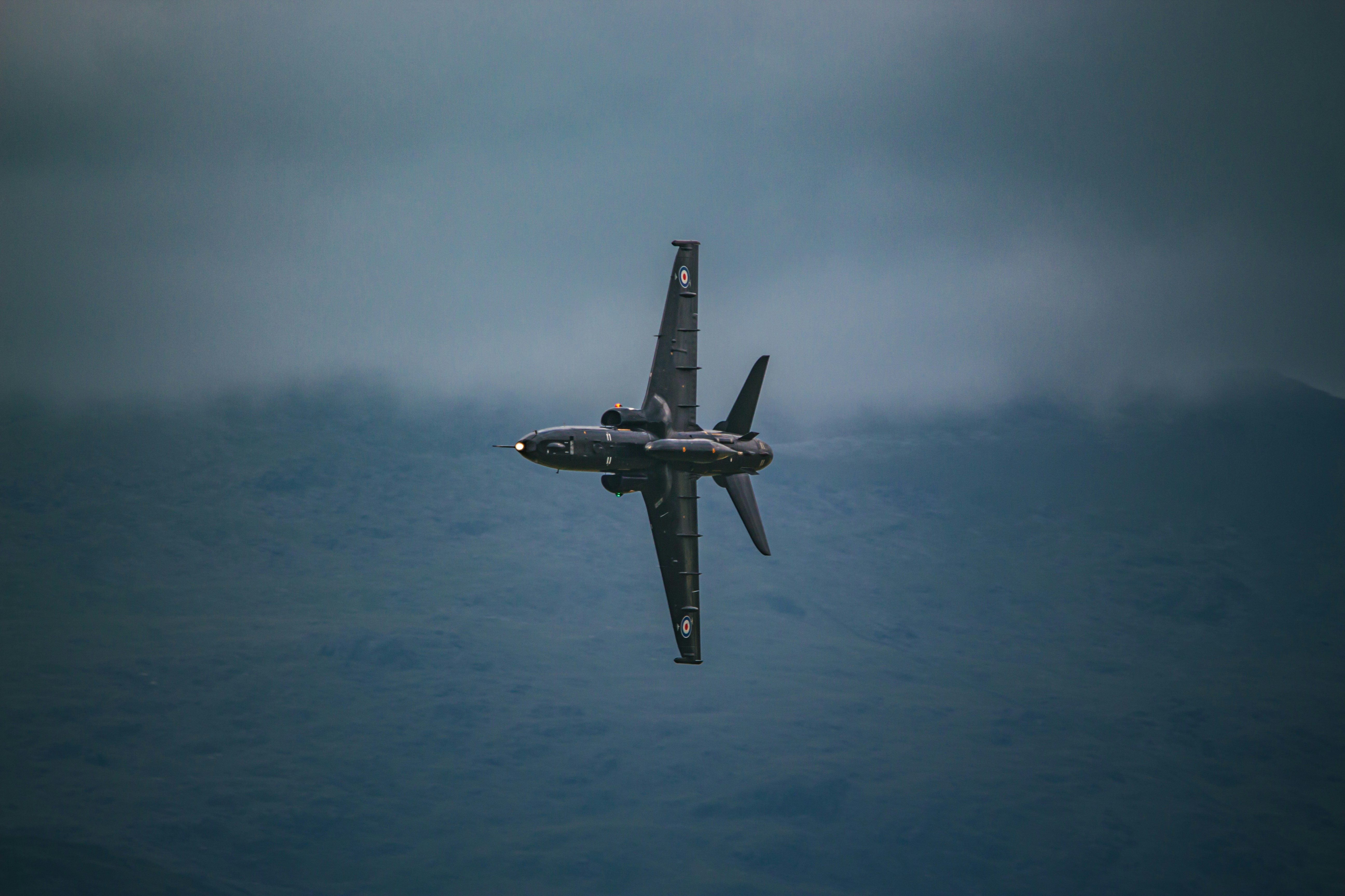 A fighter jet flying through a cloudy sky photo – Free Animal Image on ...