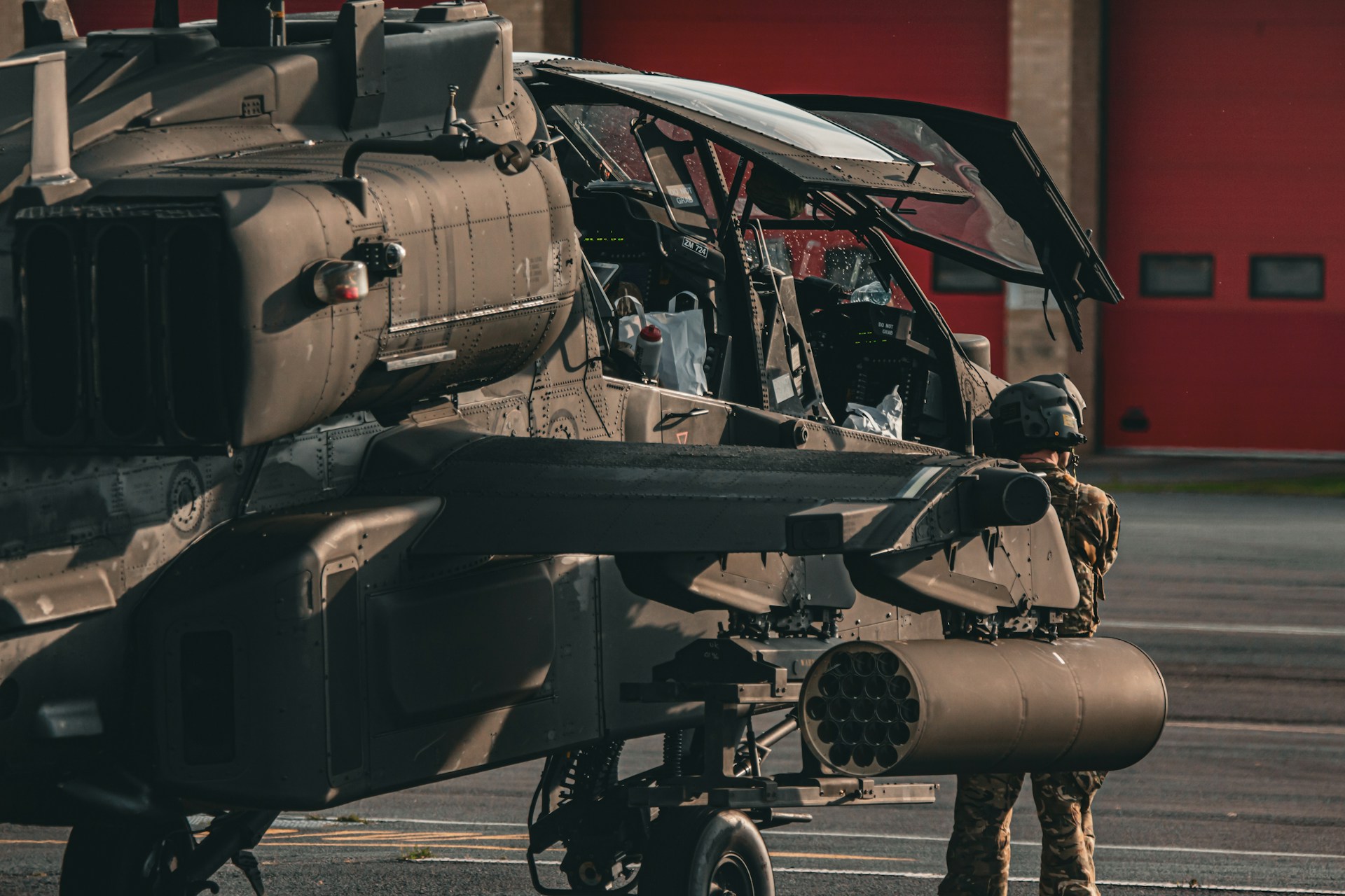 A man standing next to a military helicopter