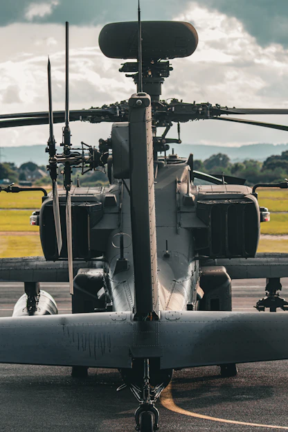 A military helicopter parked on the tarmac at an airport