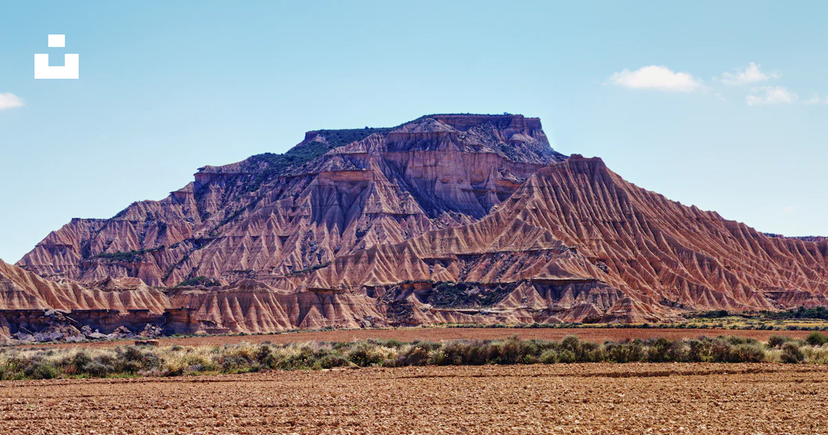 A field with a mountain in the background photo – Free Bardenas reales ...