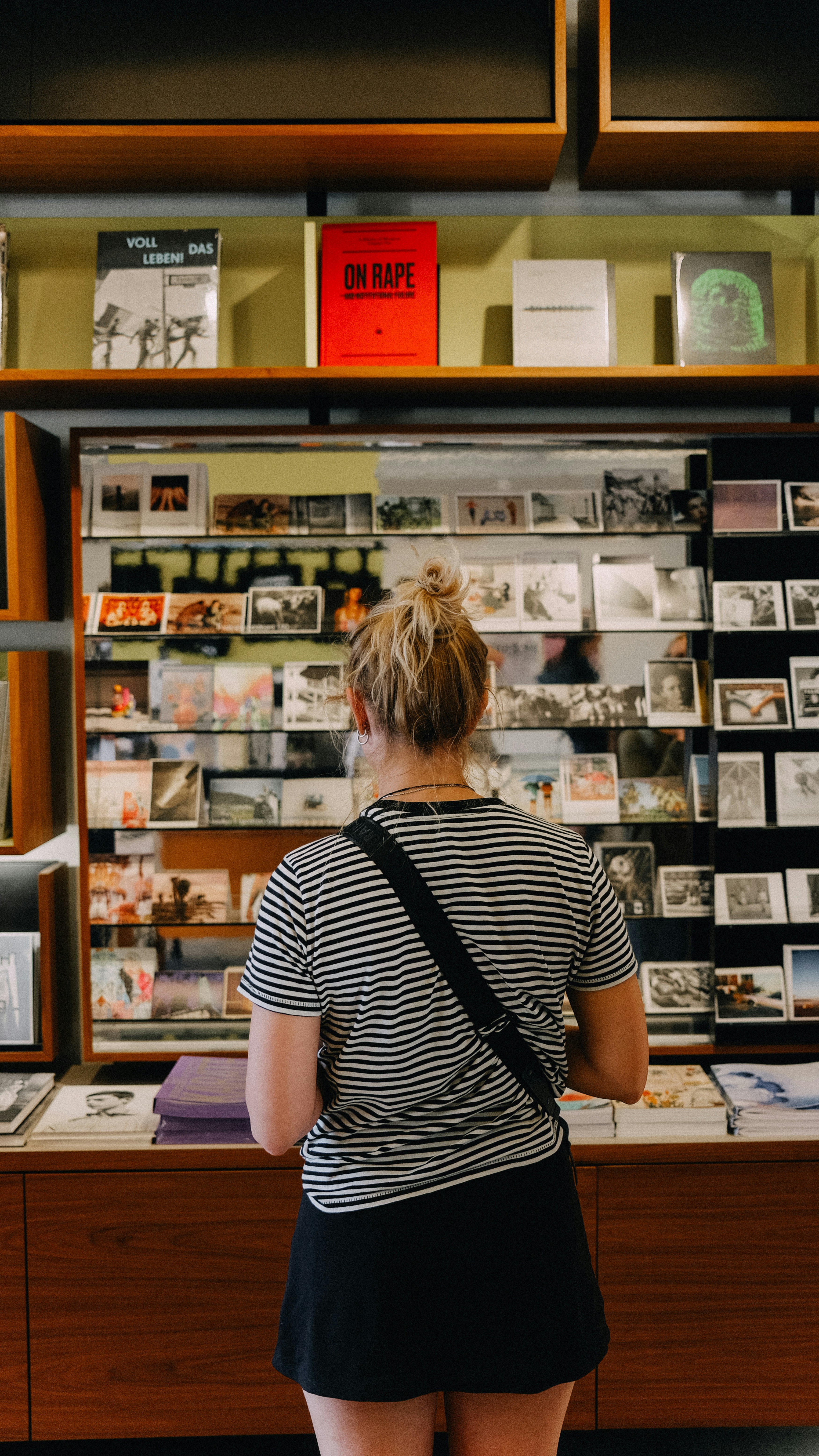 A woman standing in front of a display of books