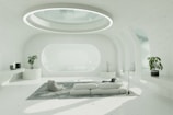 A living room with a white couch and a round window