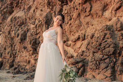 A woman in a wedding dress holding a bouquet of flowers