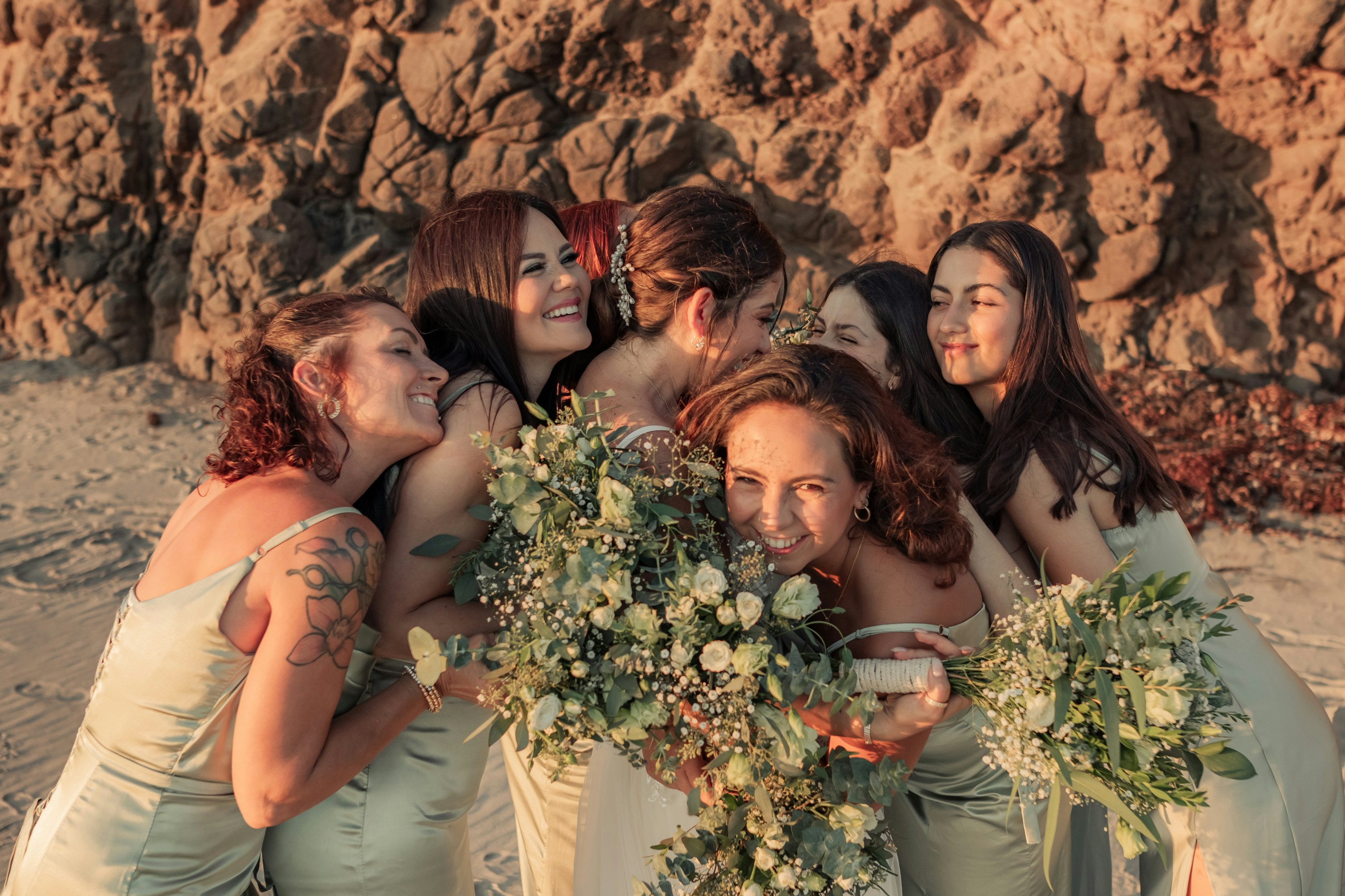 A group of women standing next to each other on a beach