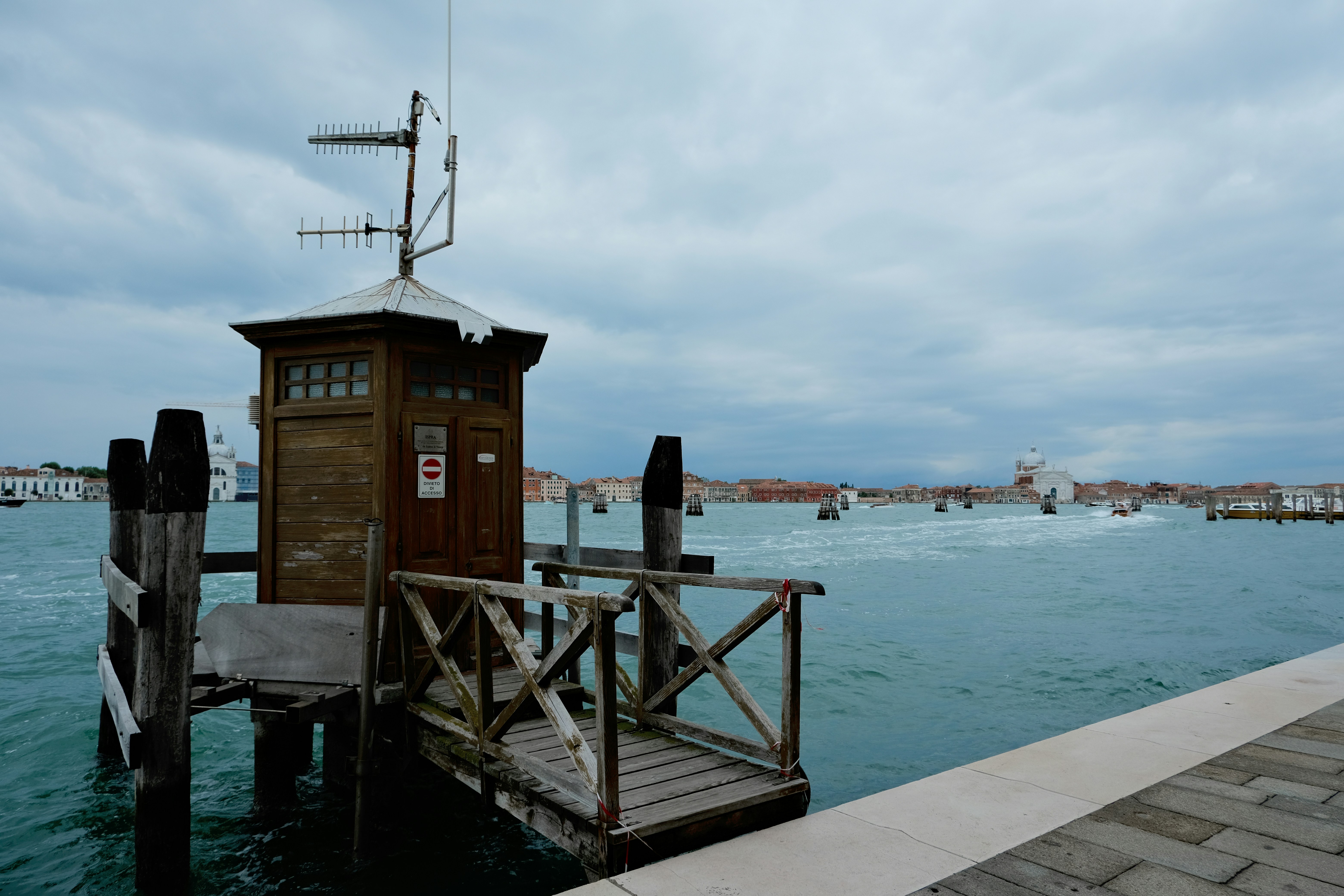A boat dock with a small tower in the middle of the water