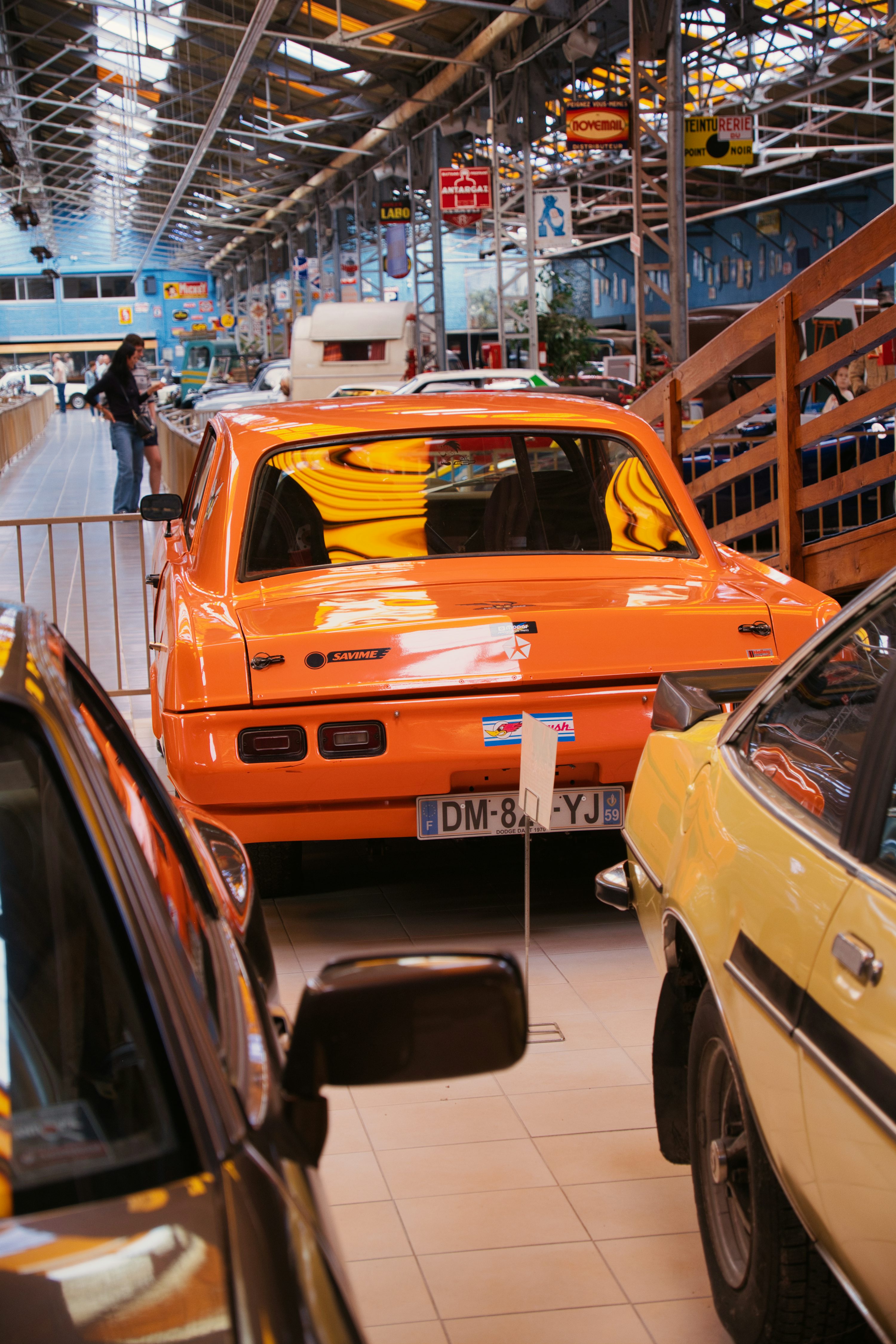 A group of cars parked inside of a garage