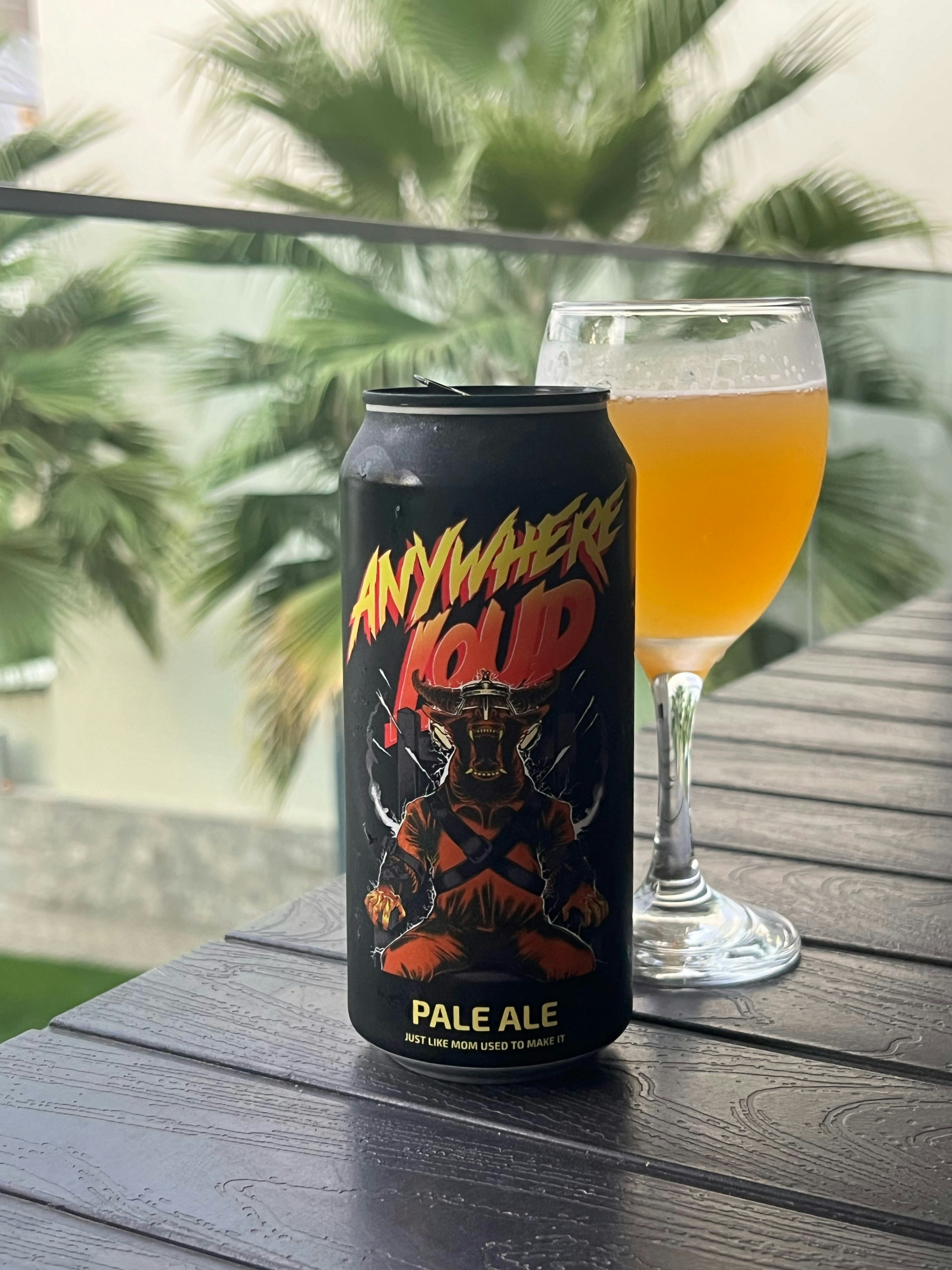 A can of beer sitting on top of a wooden table