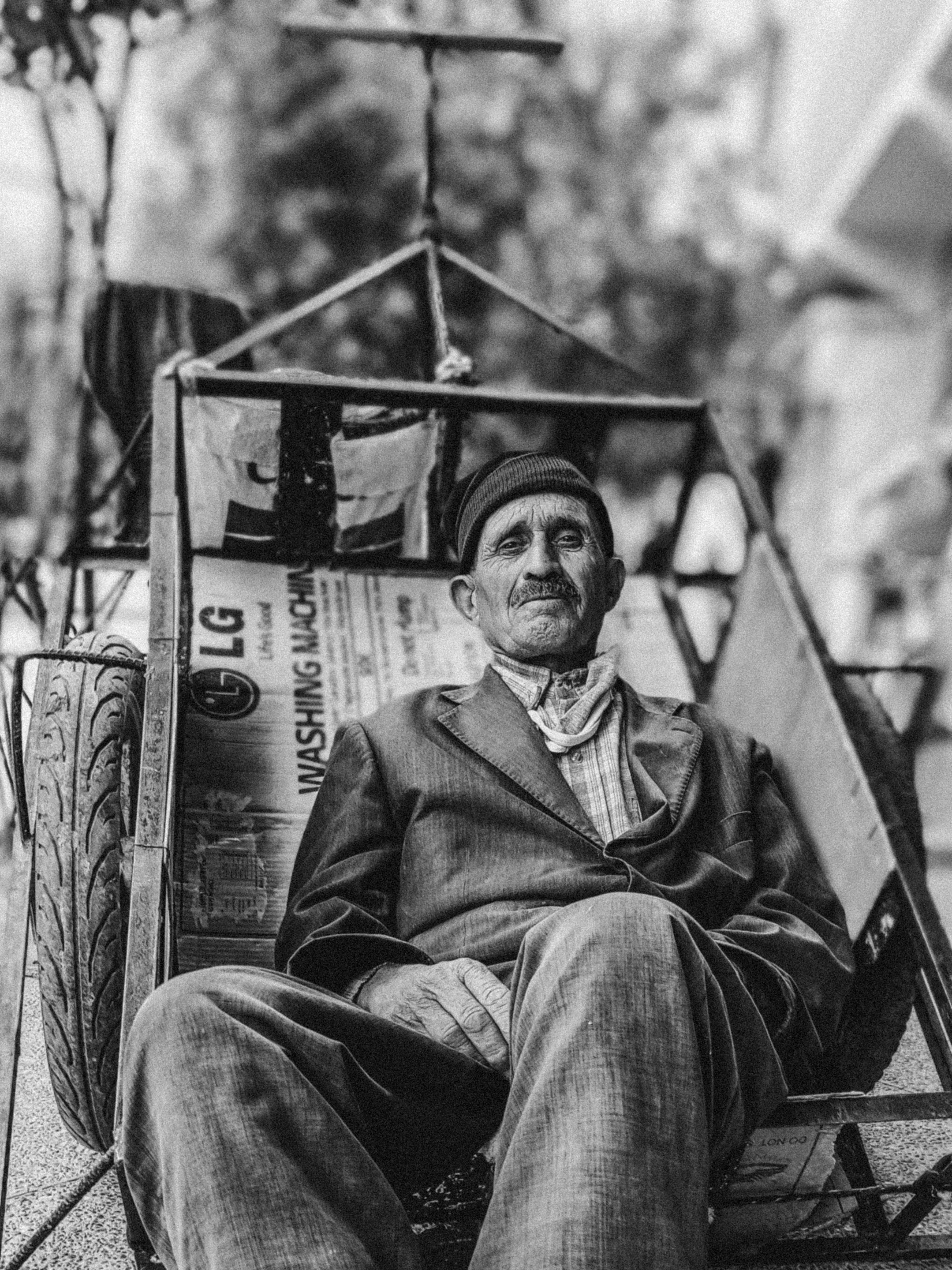 A man sitting in a chair with a hat on