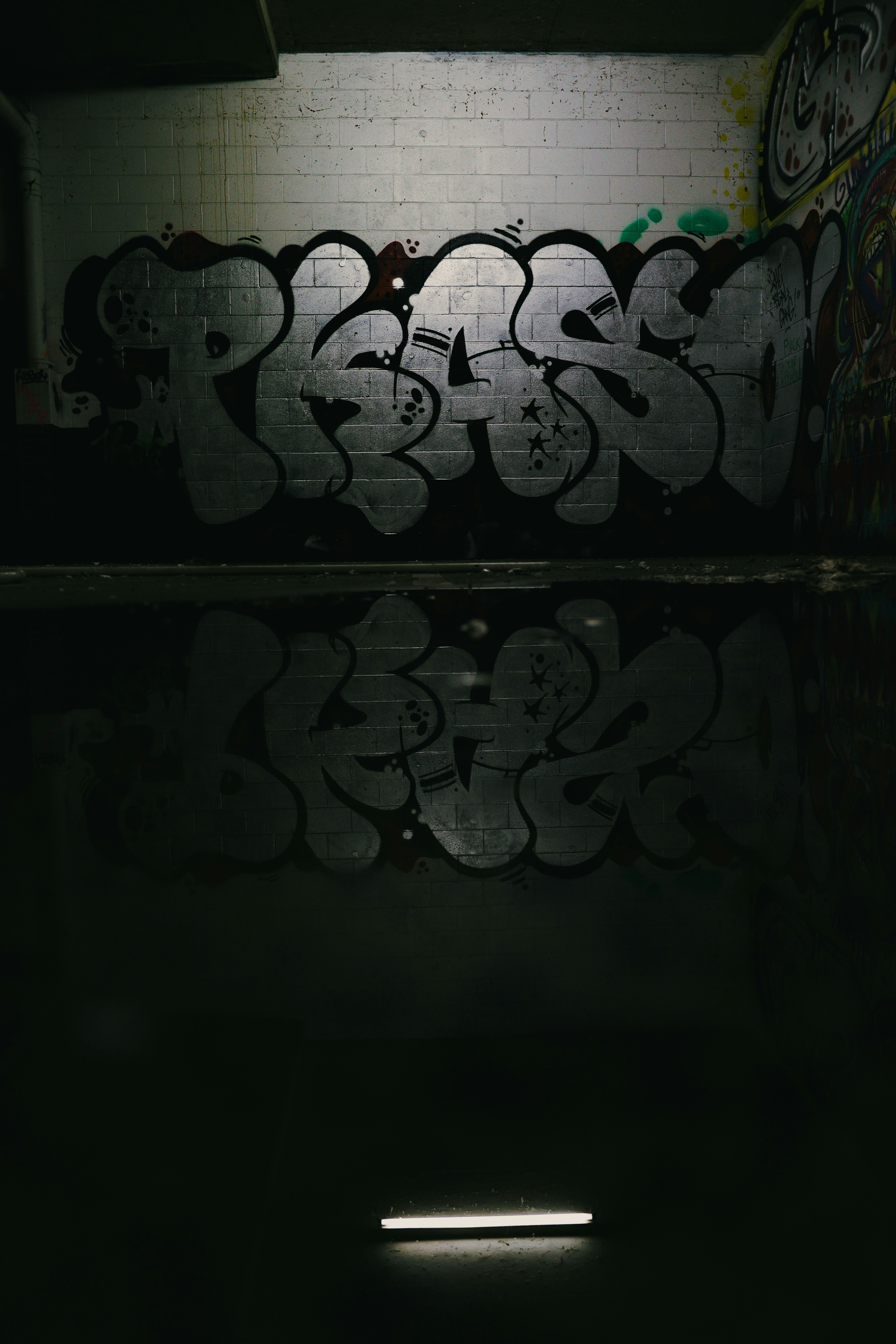 A dark room with graffiti on the walls