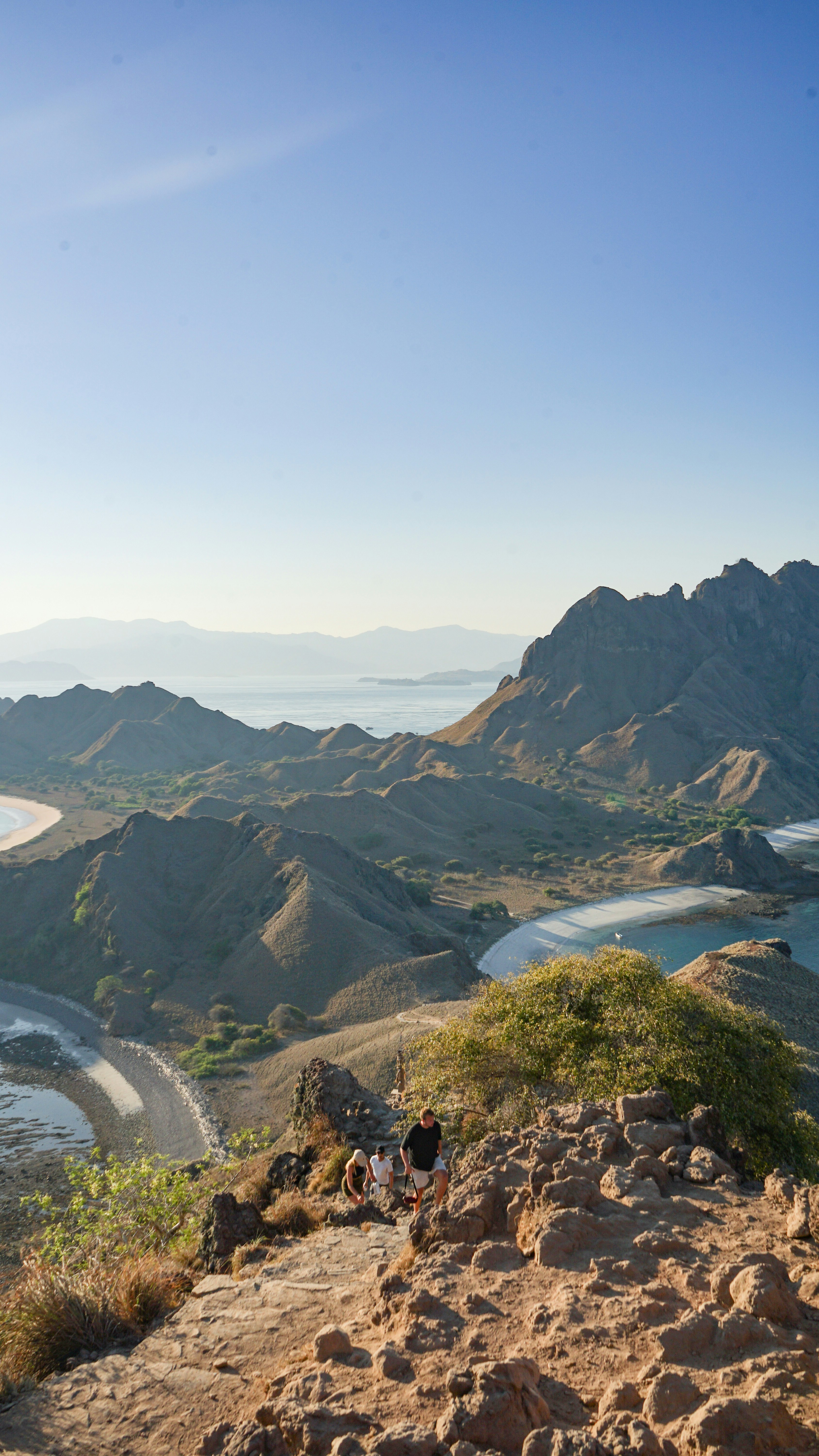 A group of people standing on top of a mountain