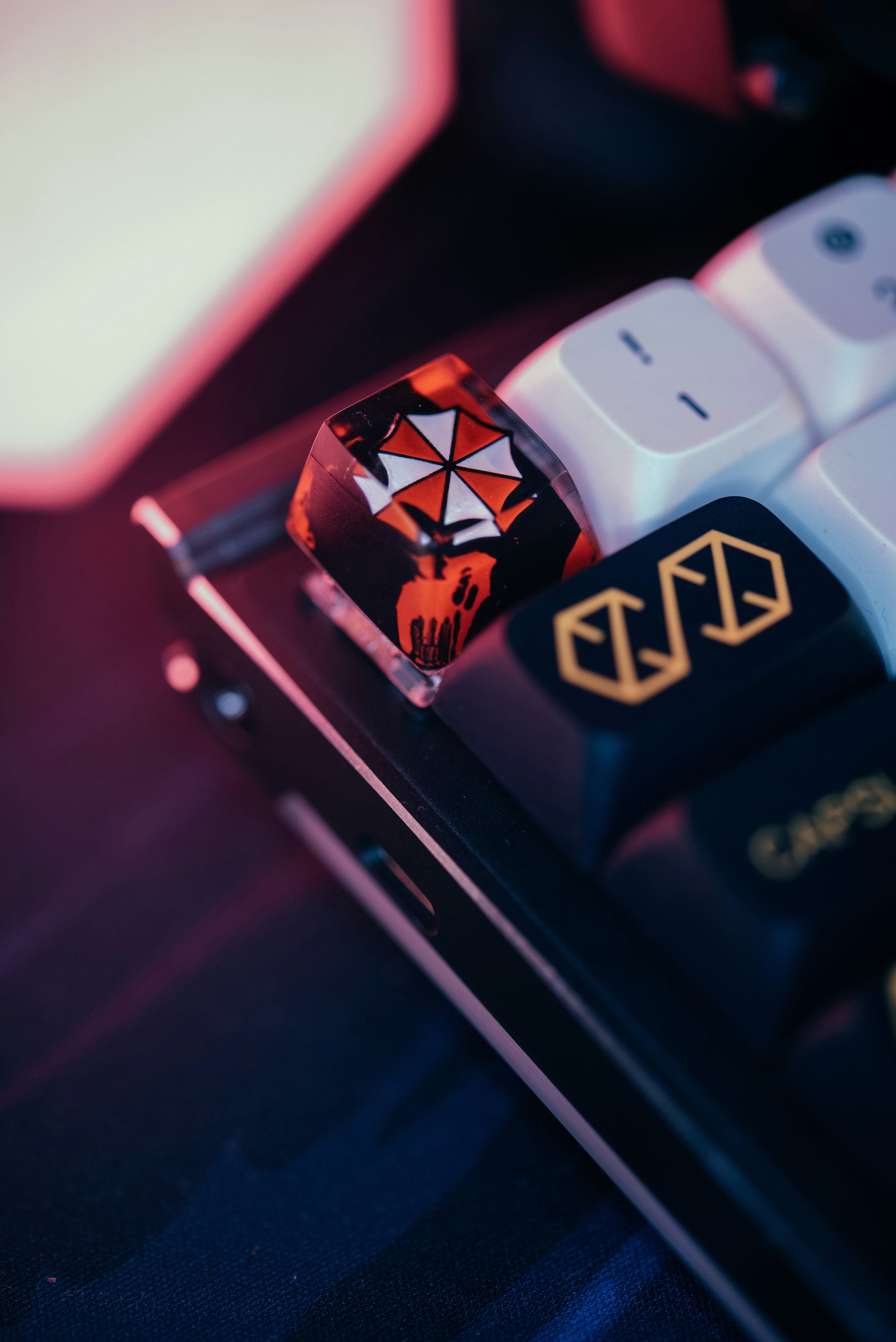 A close up of a computer keyboard with a red and white key