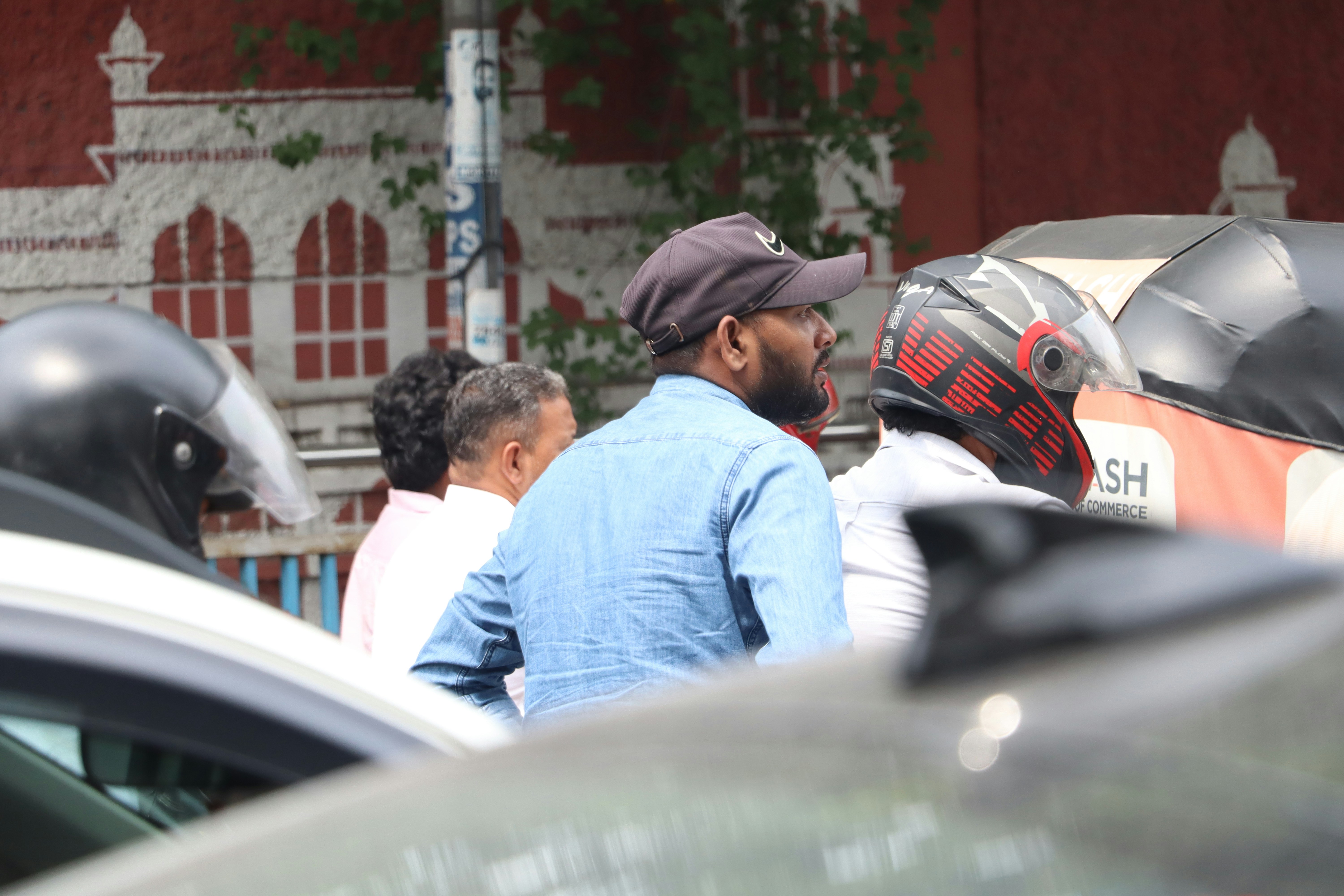 Salman Khan leaving an event, surrounded by heavily armed security personnel, looking serious.
