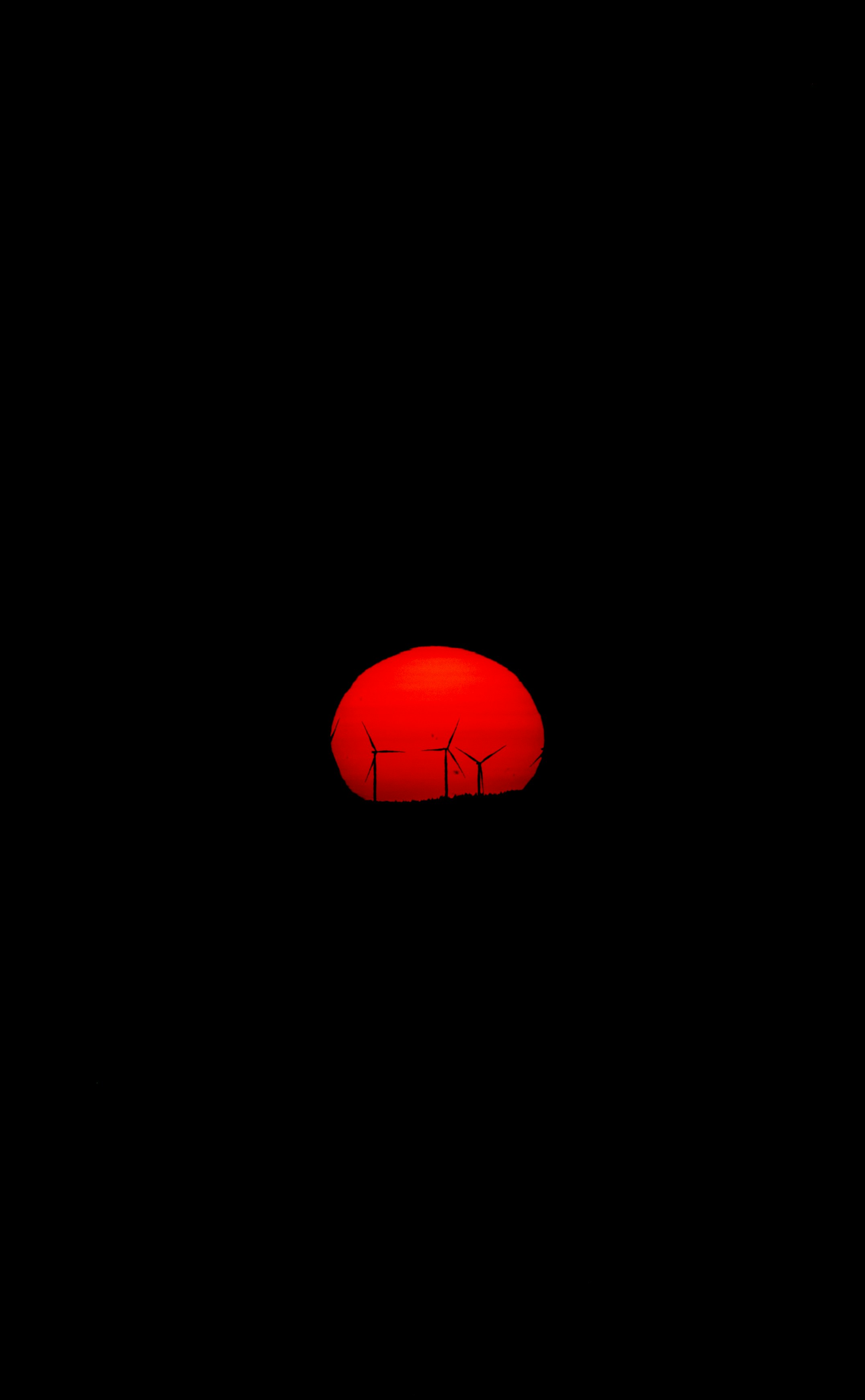 A red object in the dark with a black background