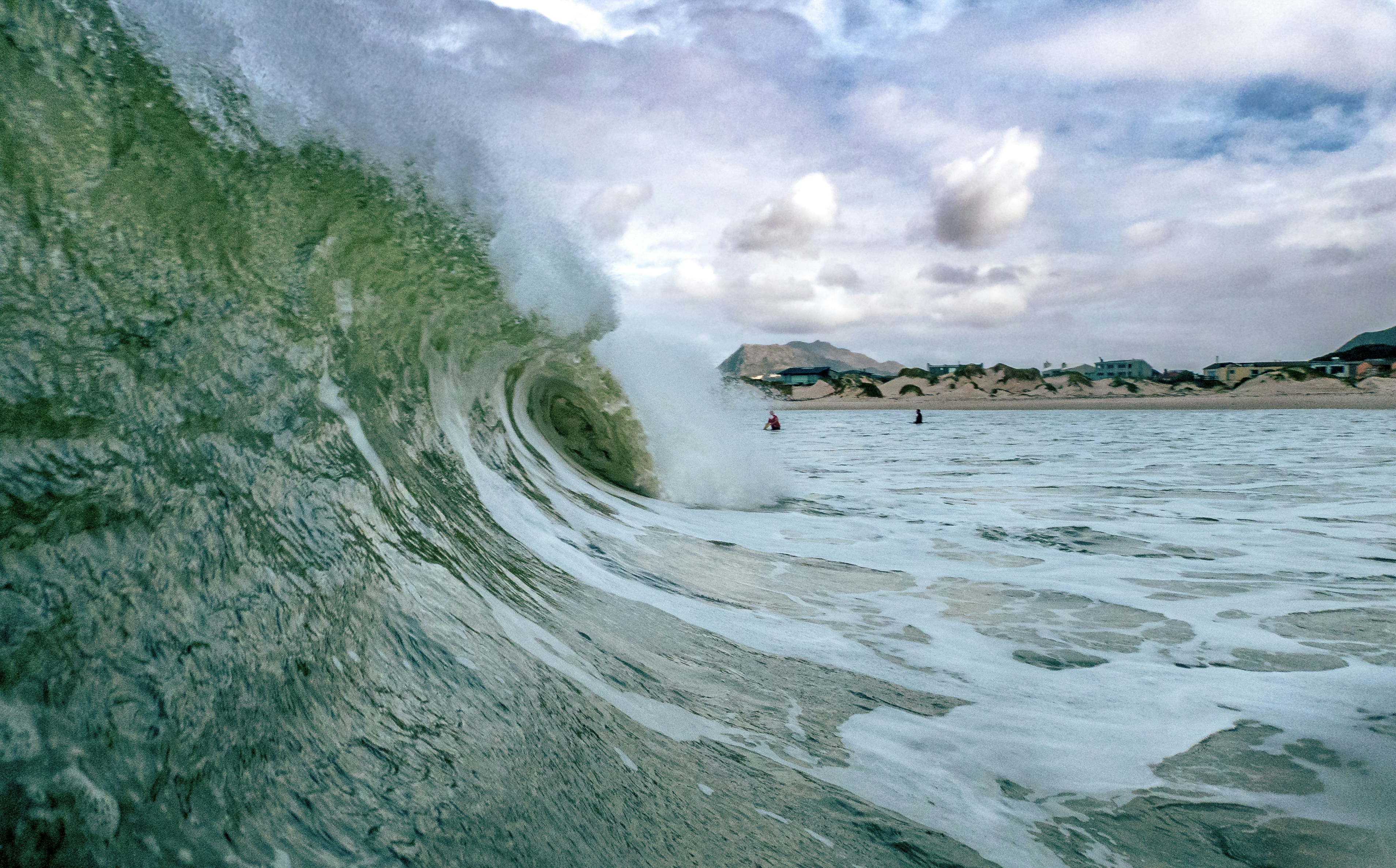 A large wave in the middle of a body of water