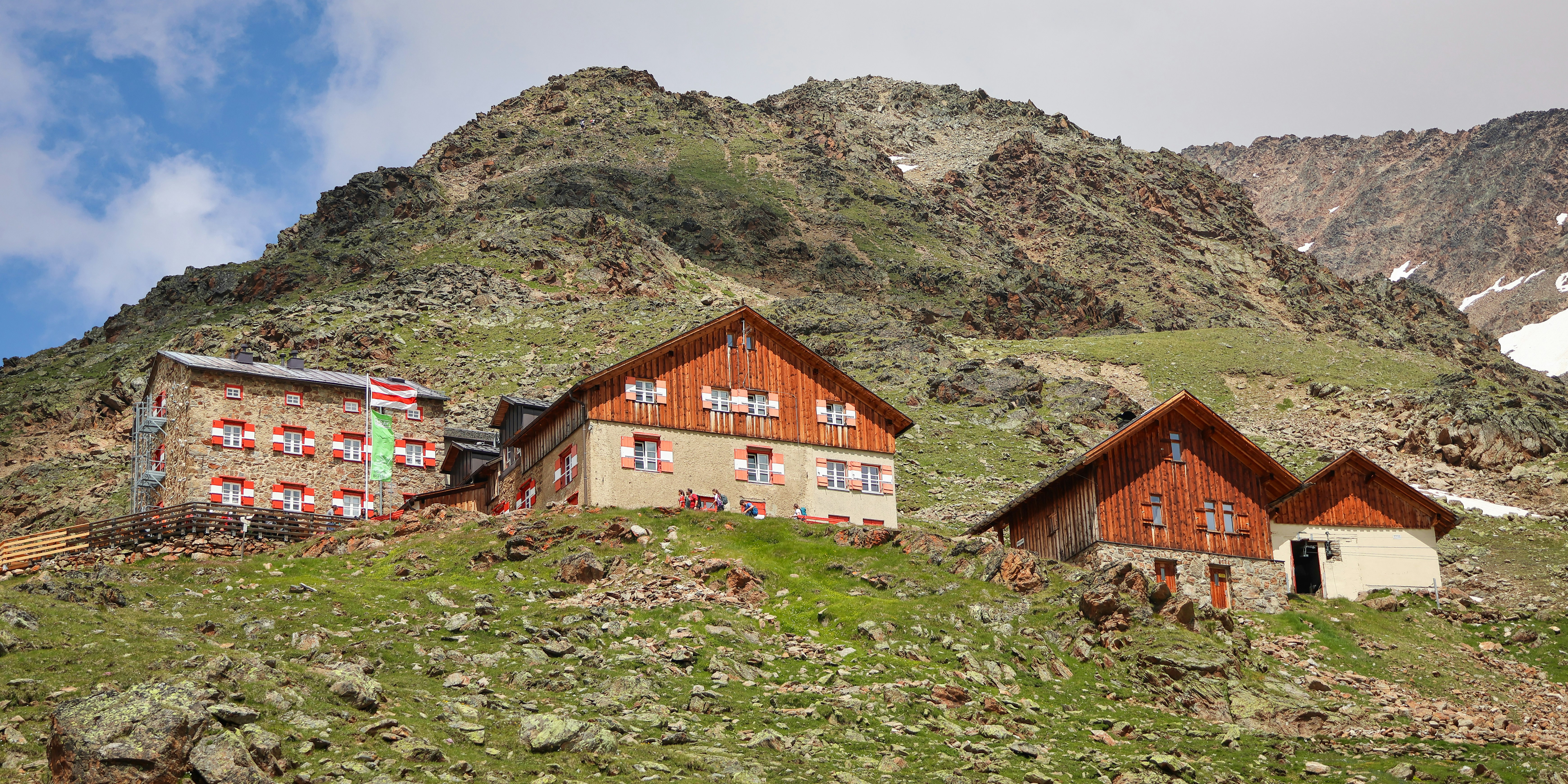 A group of houses sitting on top of a lush green hillside