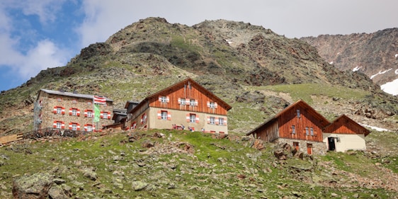 A group of houses sitting on top of a lush green hillside