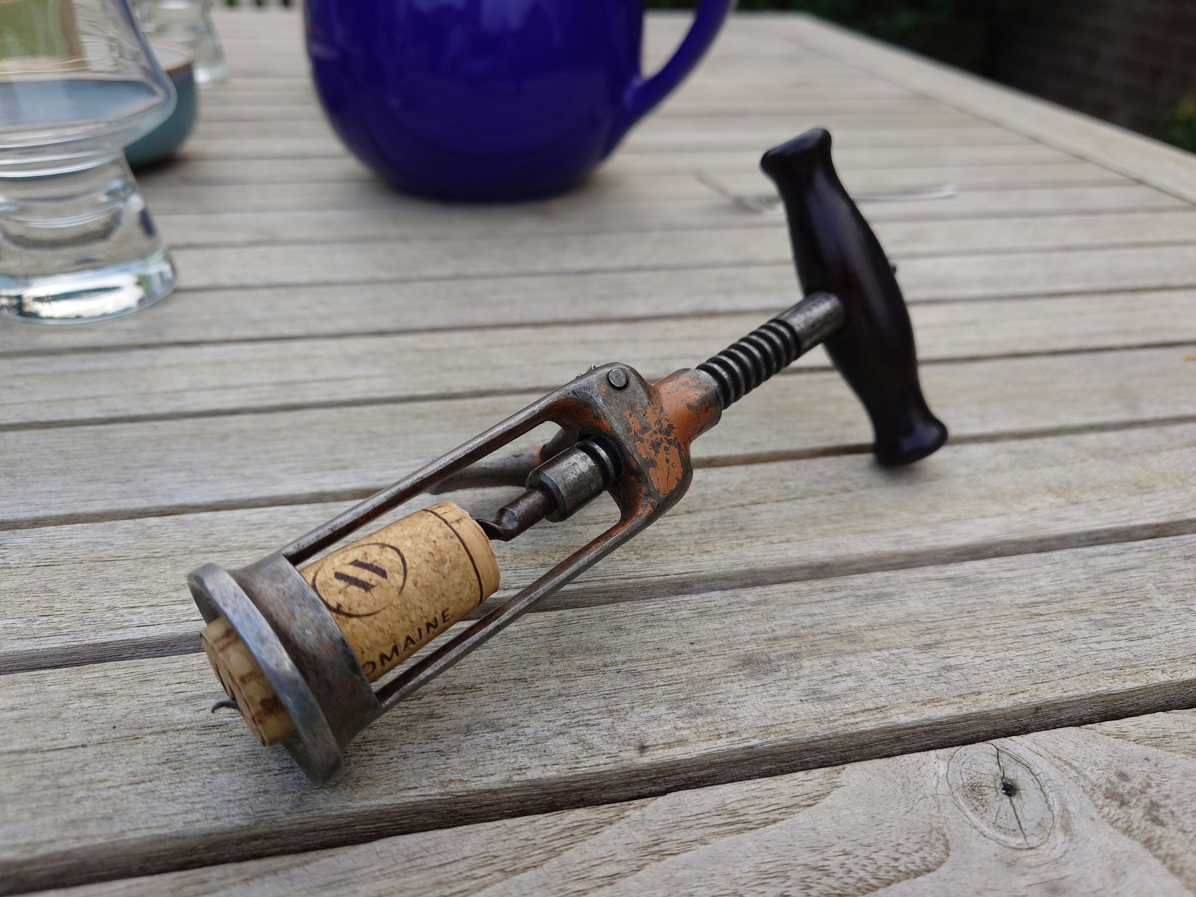 A hammer with a handle on a wooden table