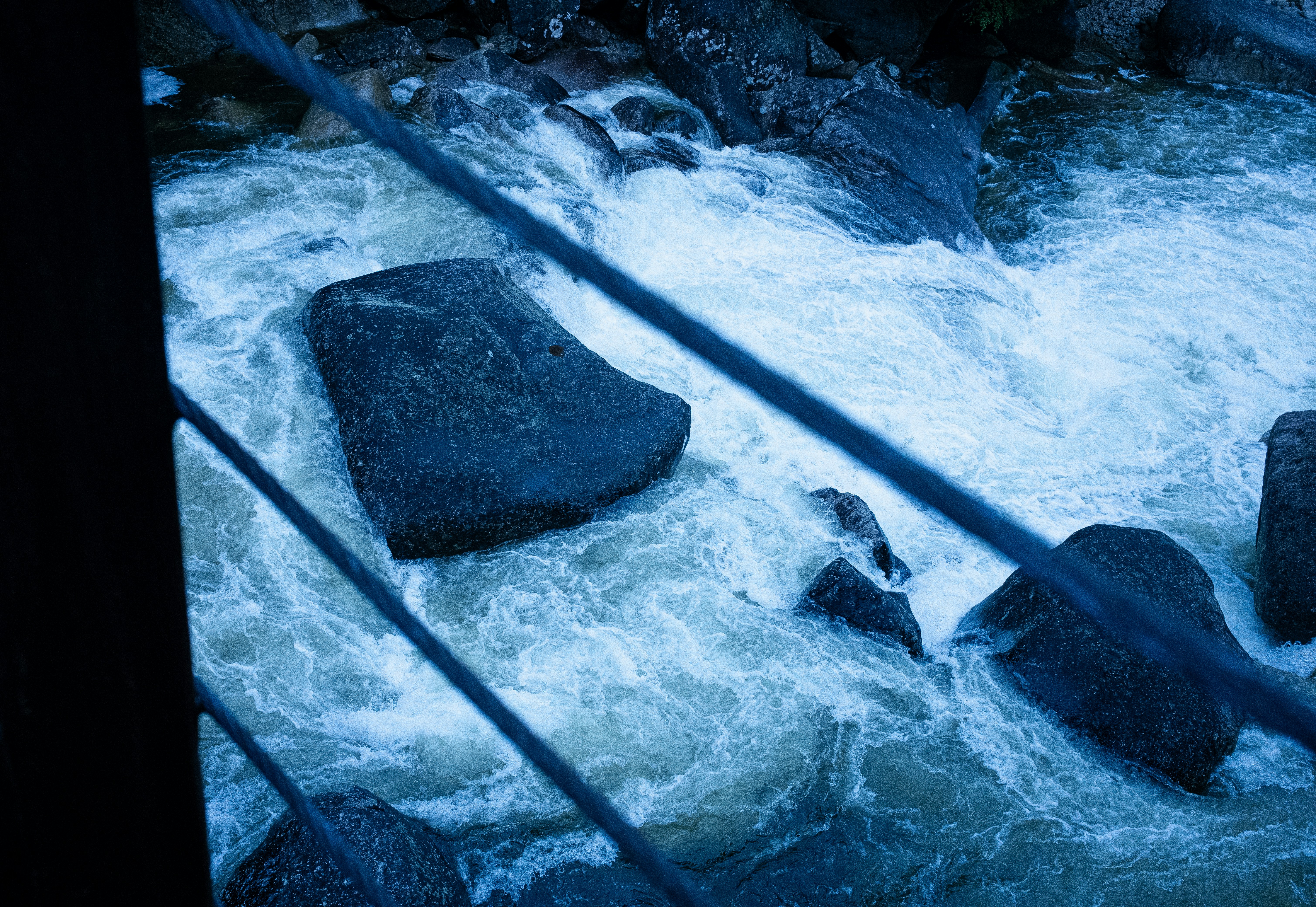 A river running through a forest filled with rocks