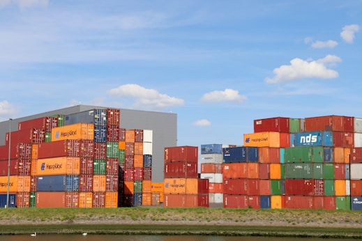 A bunch of cargo containers stacked on top of each other