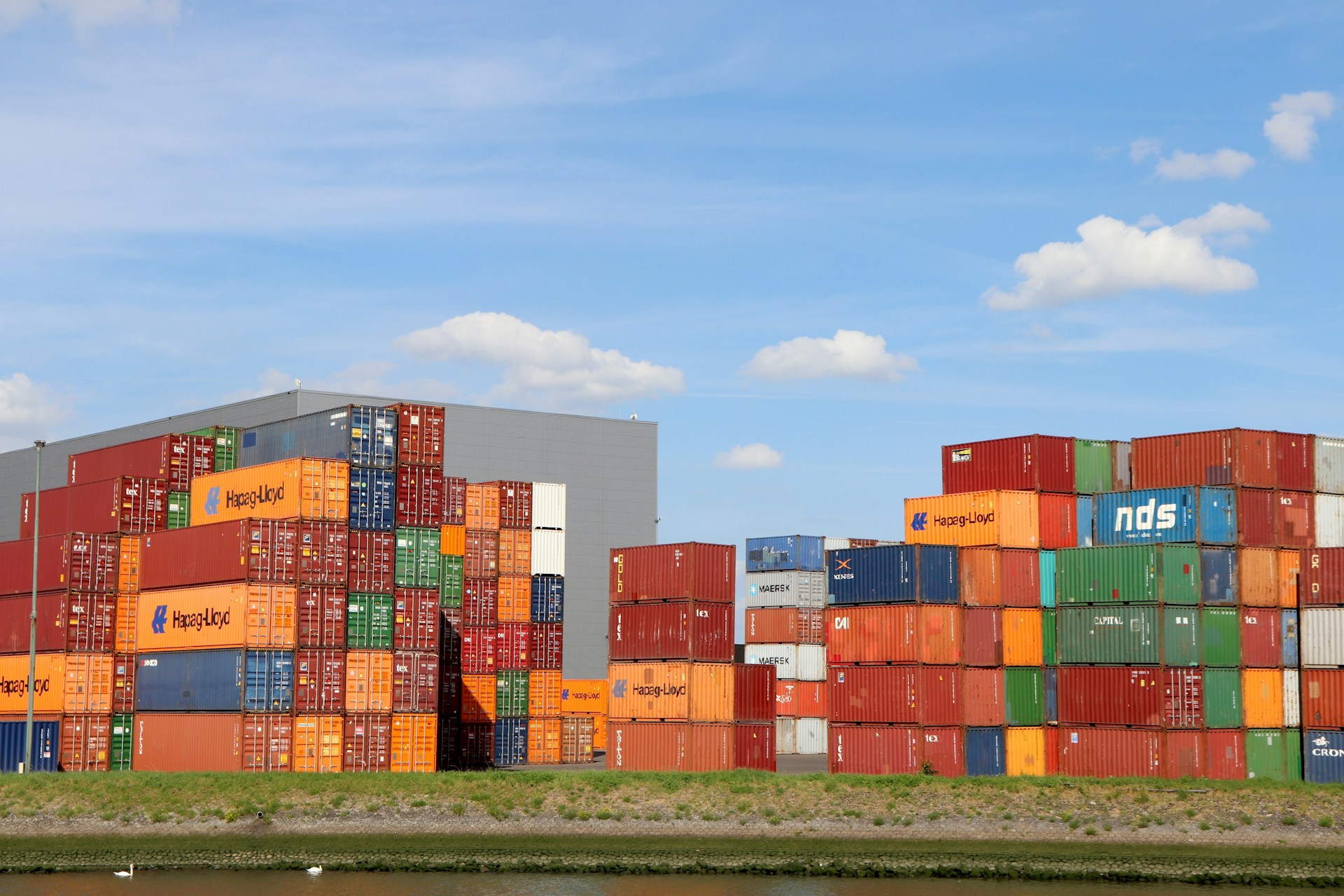 A bunch of cargo containers stacked on top of each other