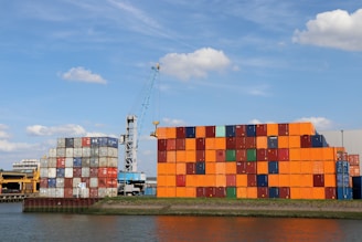 A large orange building sitting next to a body of water
