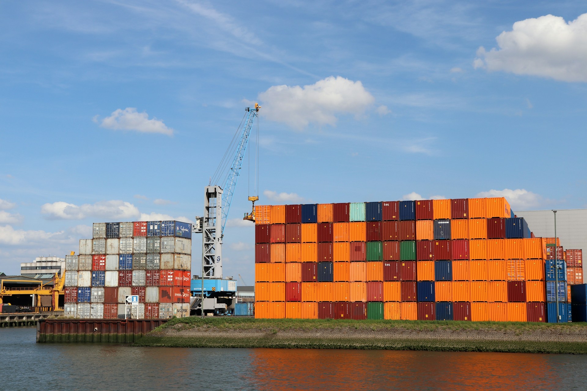 A large orange building sitting next to a body of water