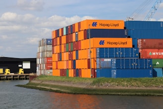 A large cargo ship sitting next to a body of water