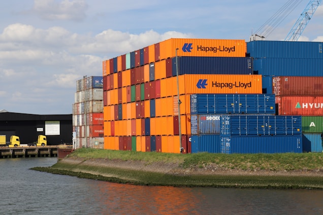 A large cargo ship sitting next to a body of water