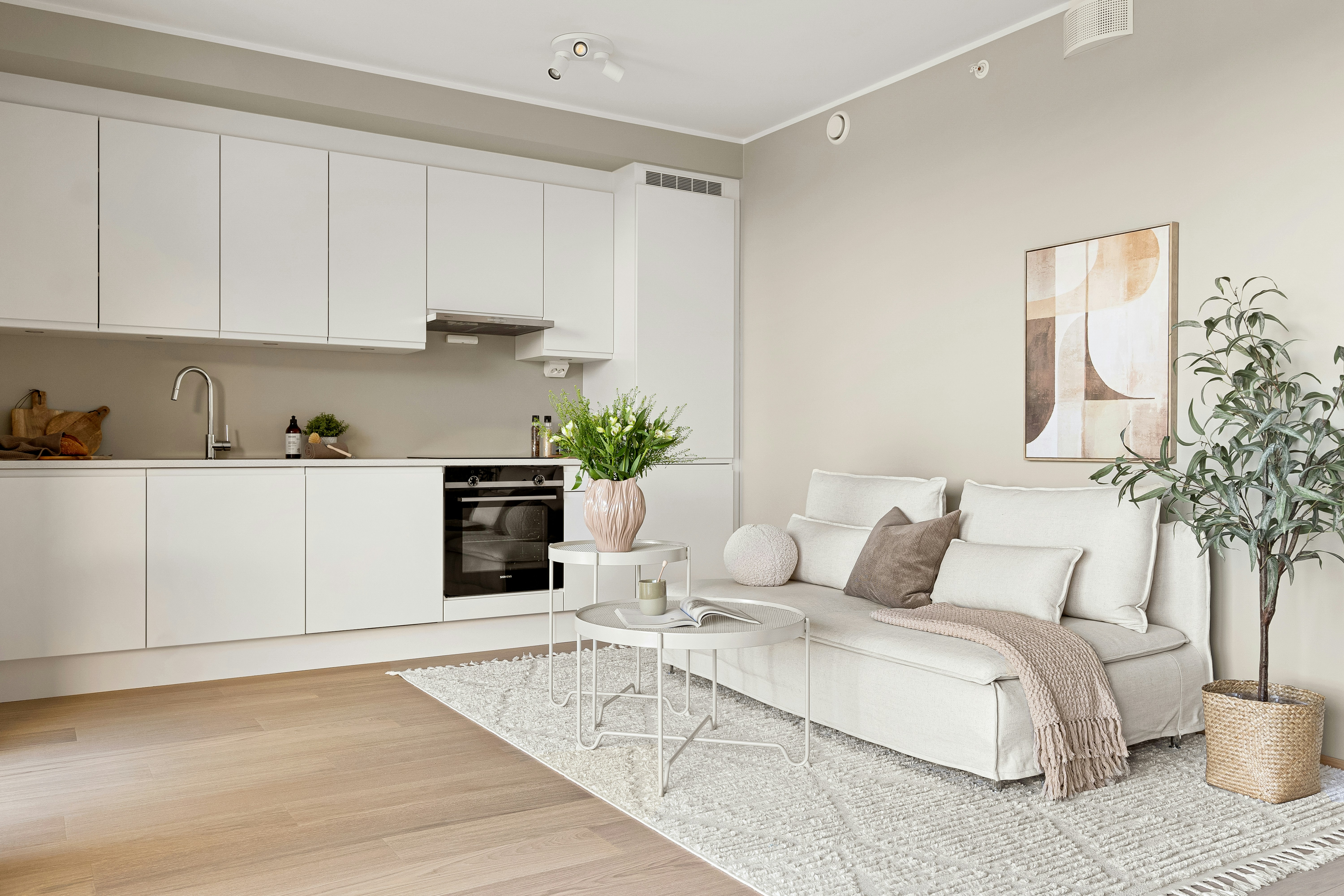 A clean, simple furnished apartment with a small kitchenette and living area, ready for an extended stay guest - extended stay cost per week