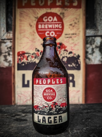 A beer bottle sitting on top of a wooden table