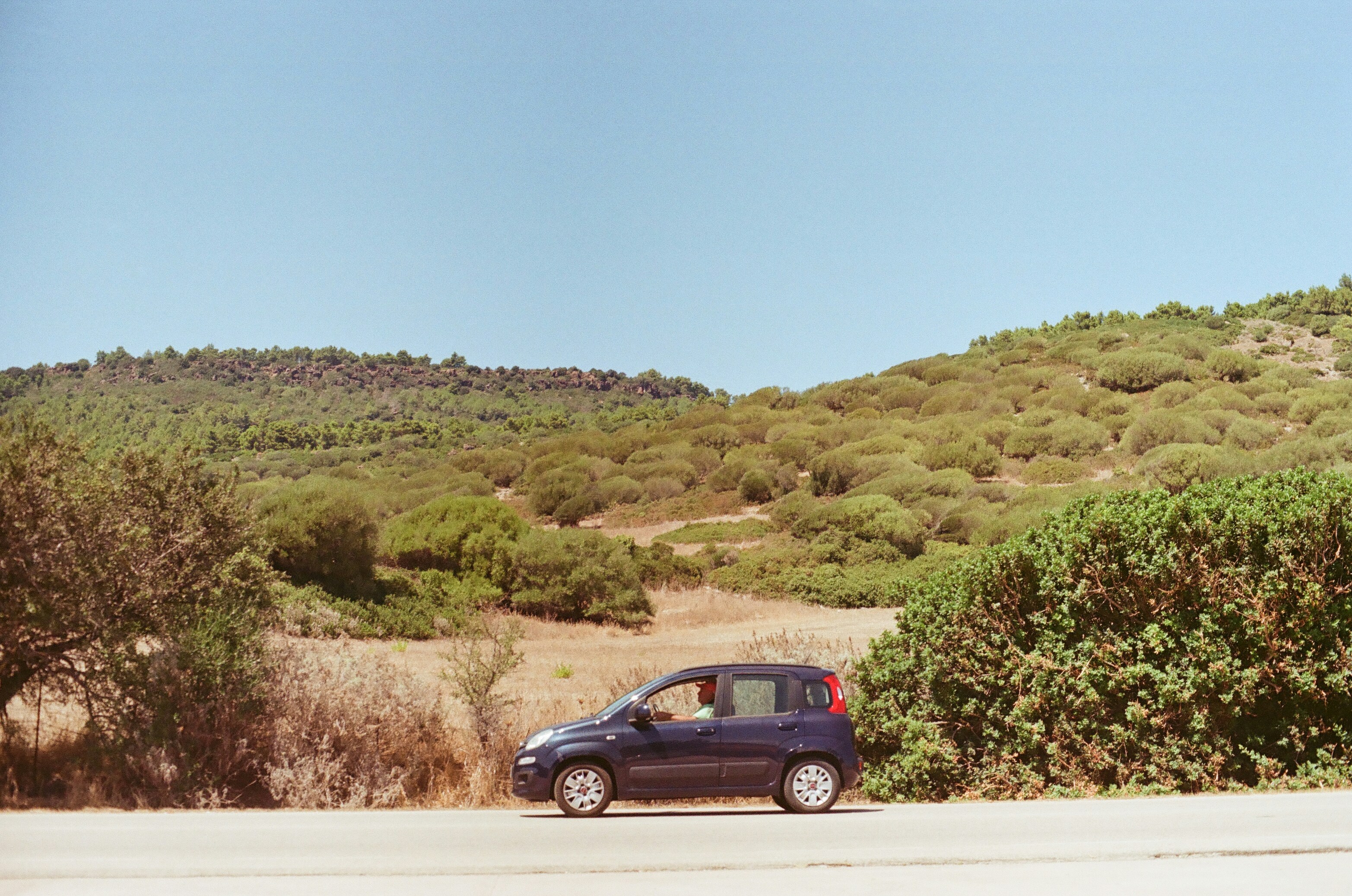 A small car is parked on the side of the road