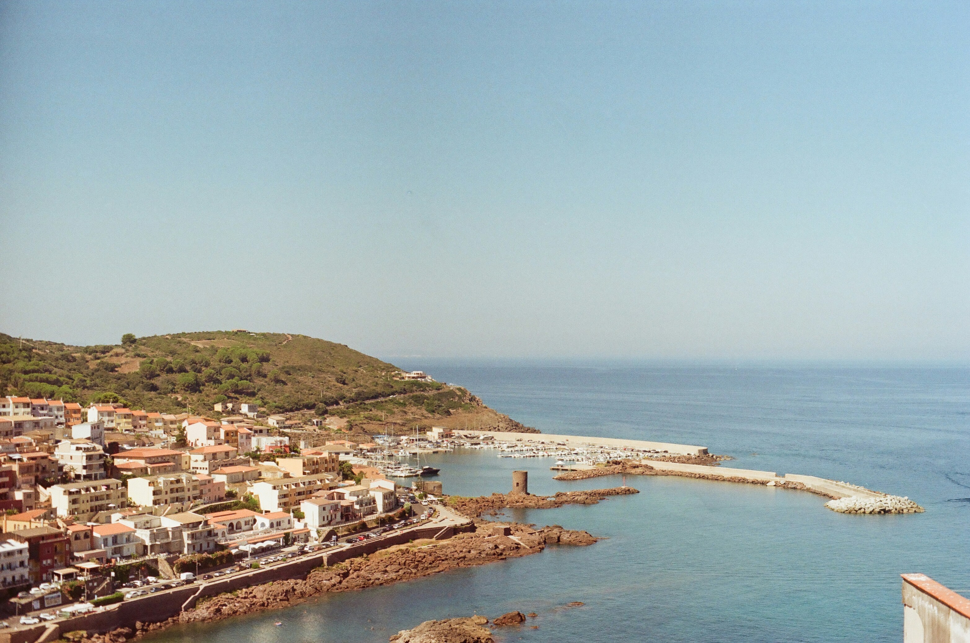 A view of a small town by the ocean, a 35mm photo taken in Sardinia