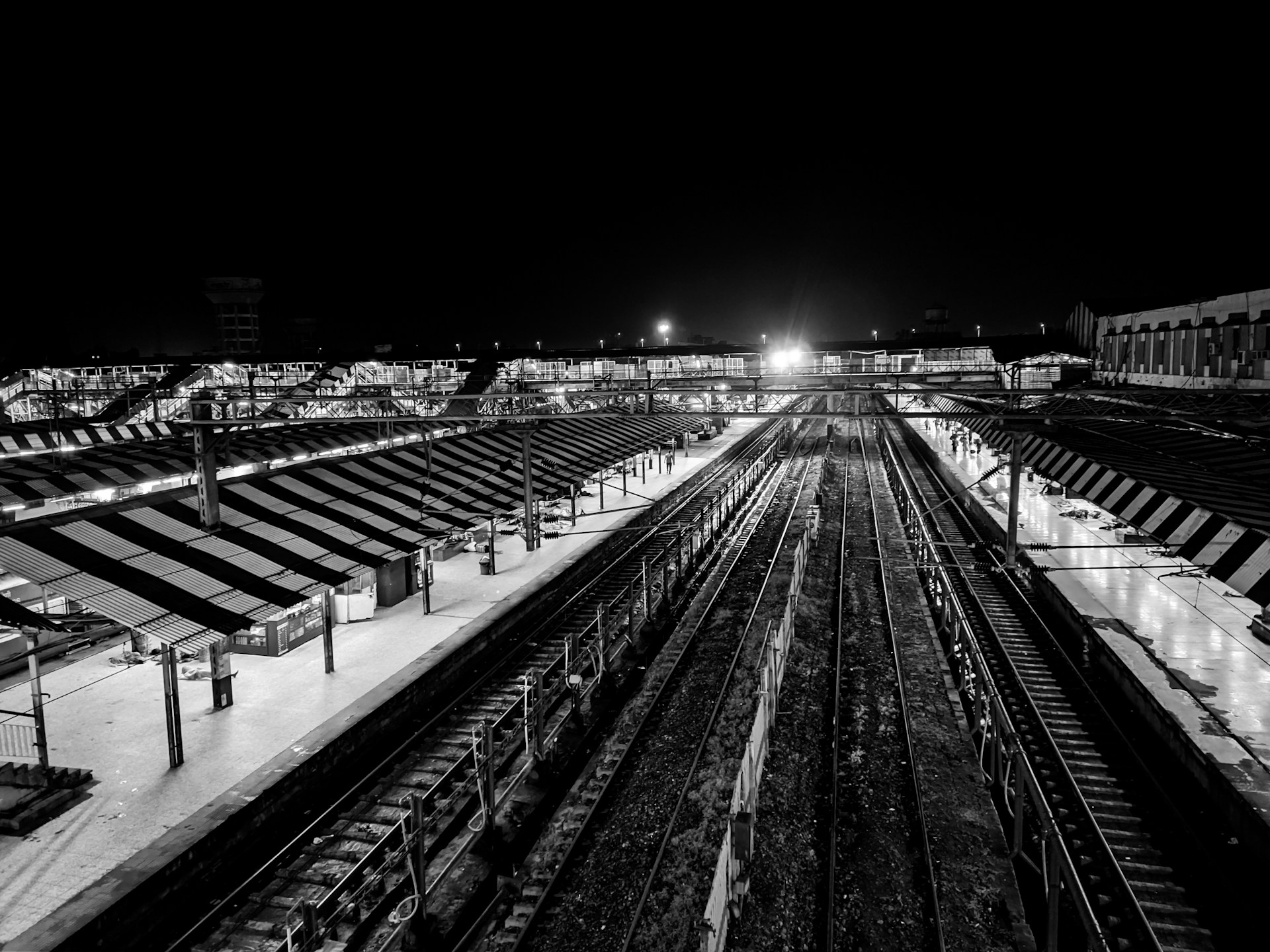 A black and white photo of a train station
