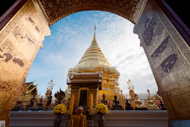 An arch leading into a temple with a sky in the background