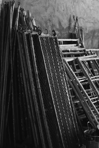 A pile of skis sitting next to a wall