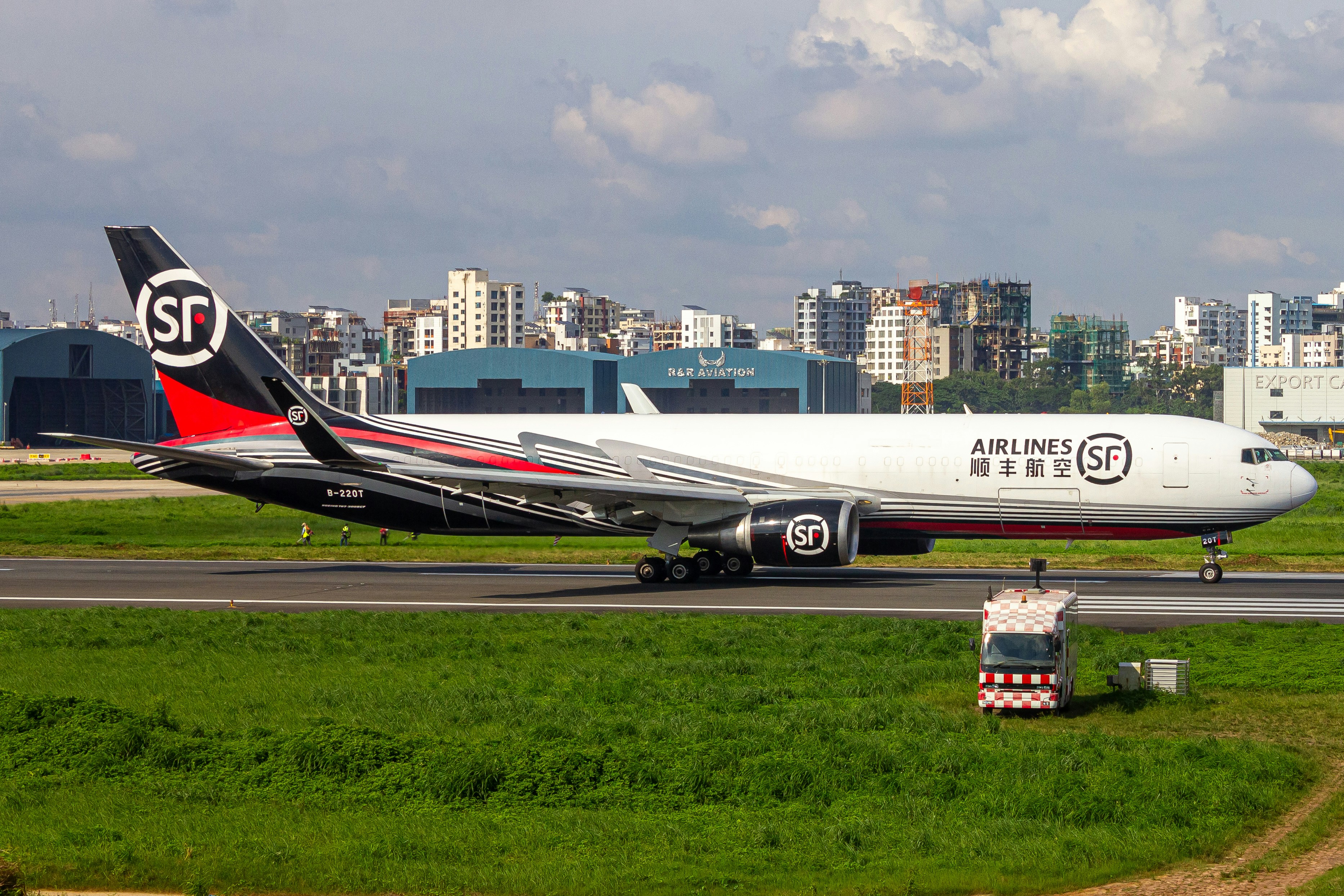 A large jetliner sitting on top of an airport runway, SF Airlines ready for takeoff