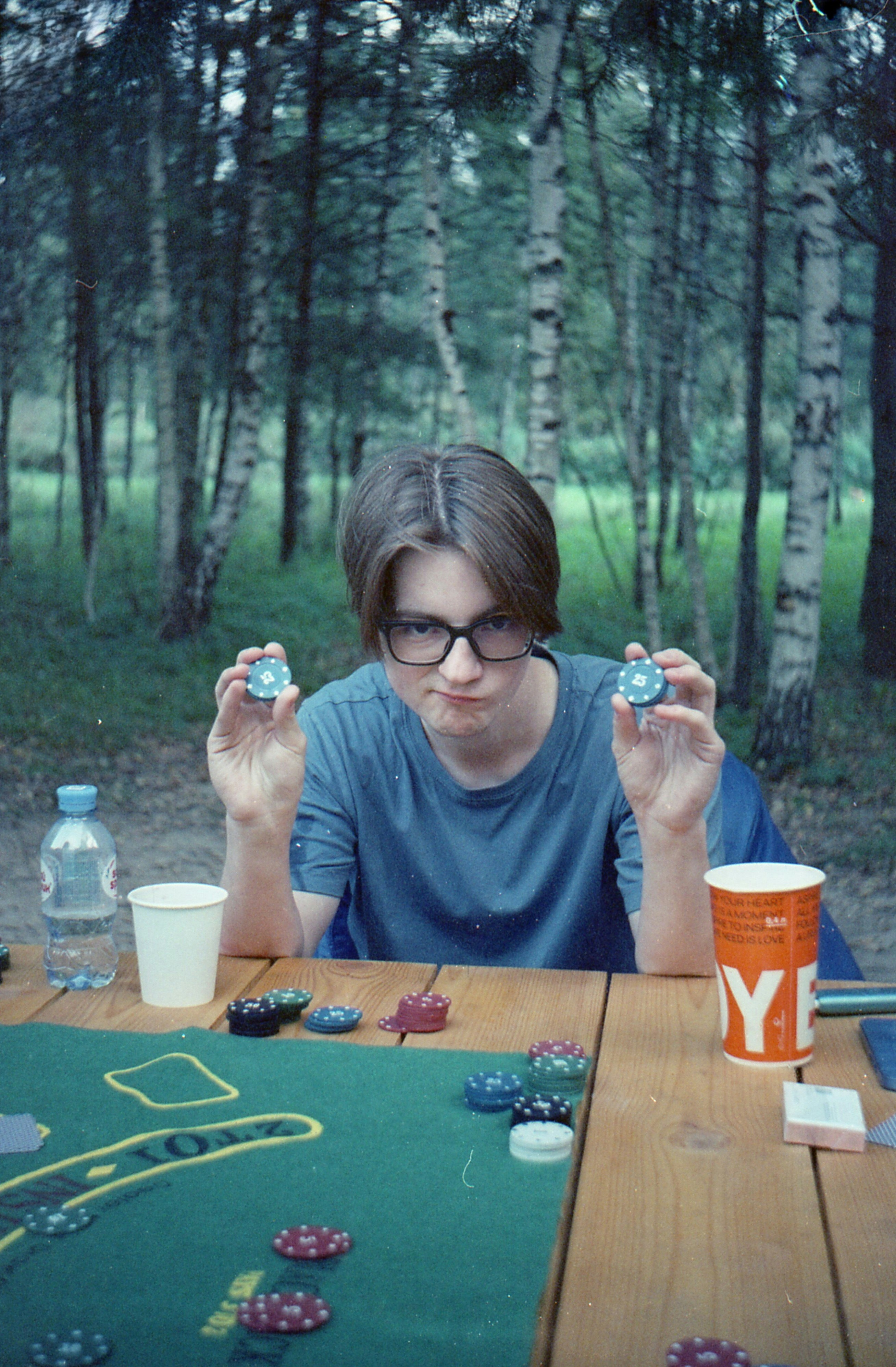 A person sitting at a table with some cards