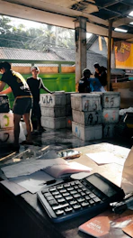 A group of people standing around a table with a keyboard