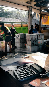 A group of people standing around a table with a keyboard