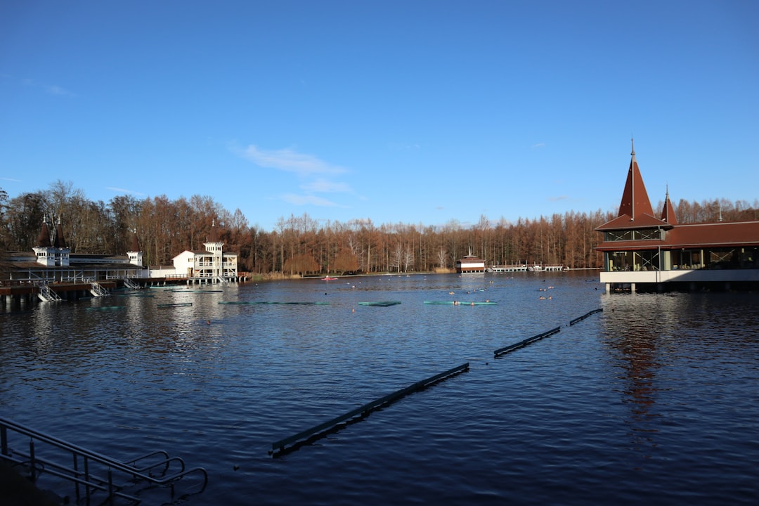 A large body of water with a church in the background,