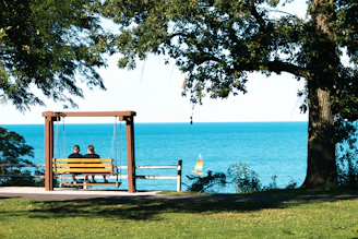 Two people sitting on a bench near the water in Winnetka IL