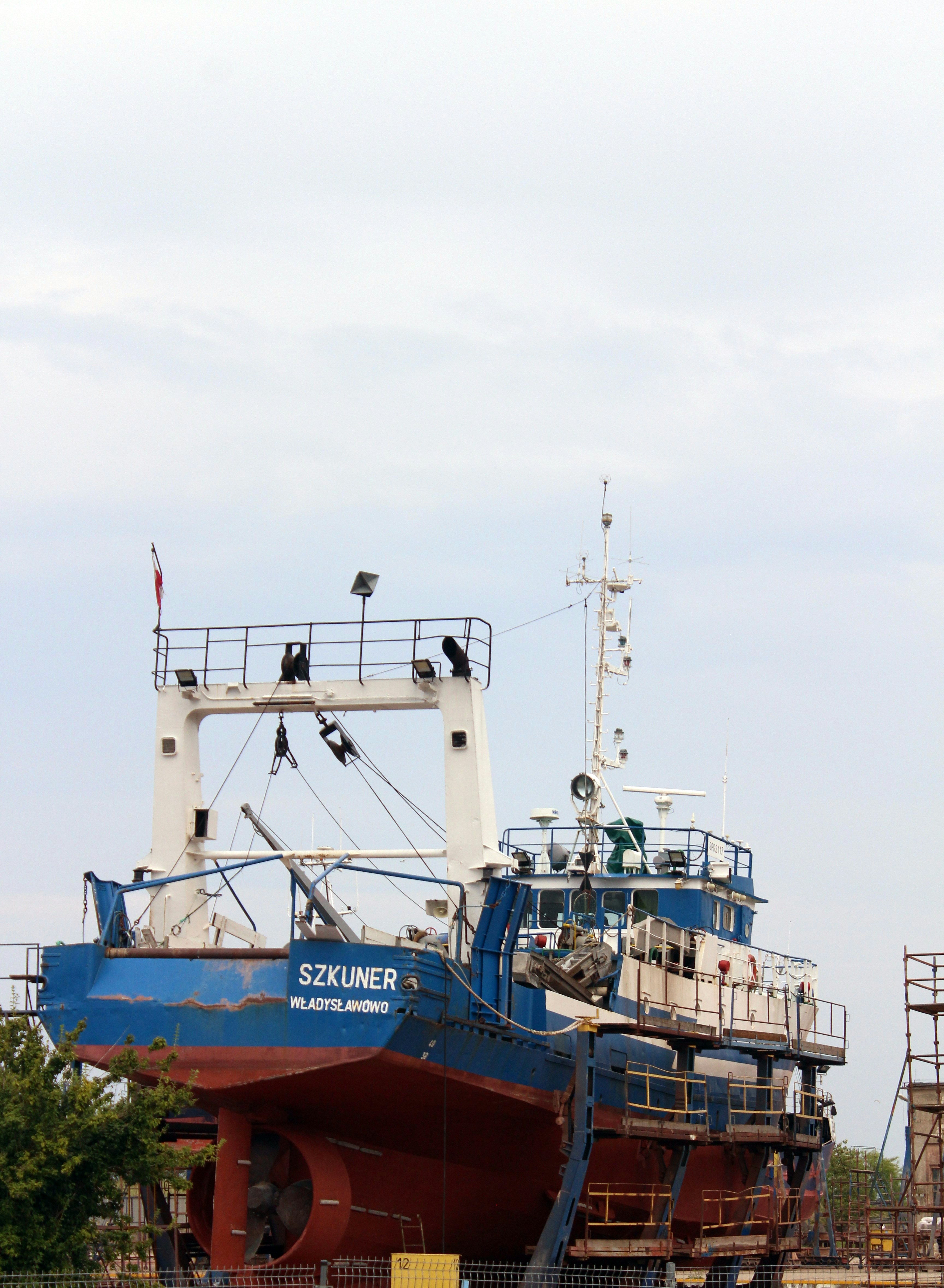A large blue and white boat sitting on top of a body of water