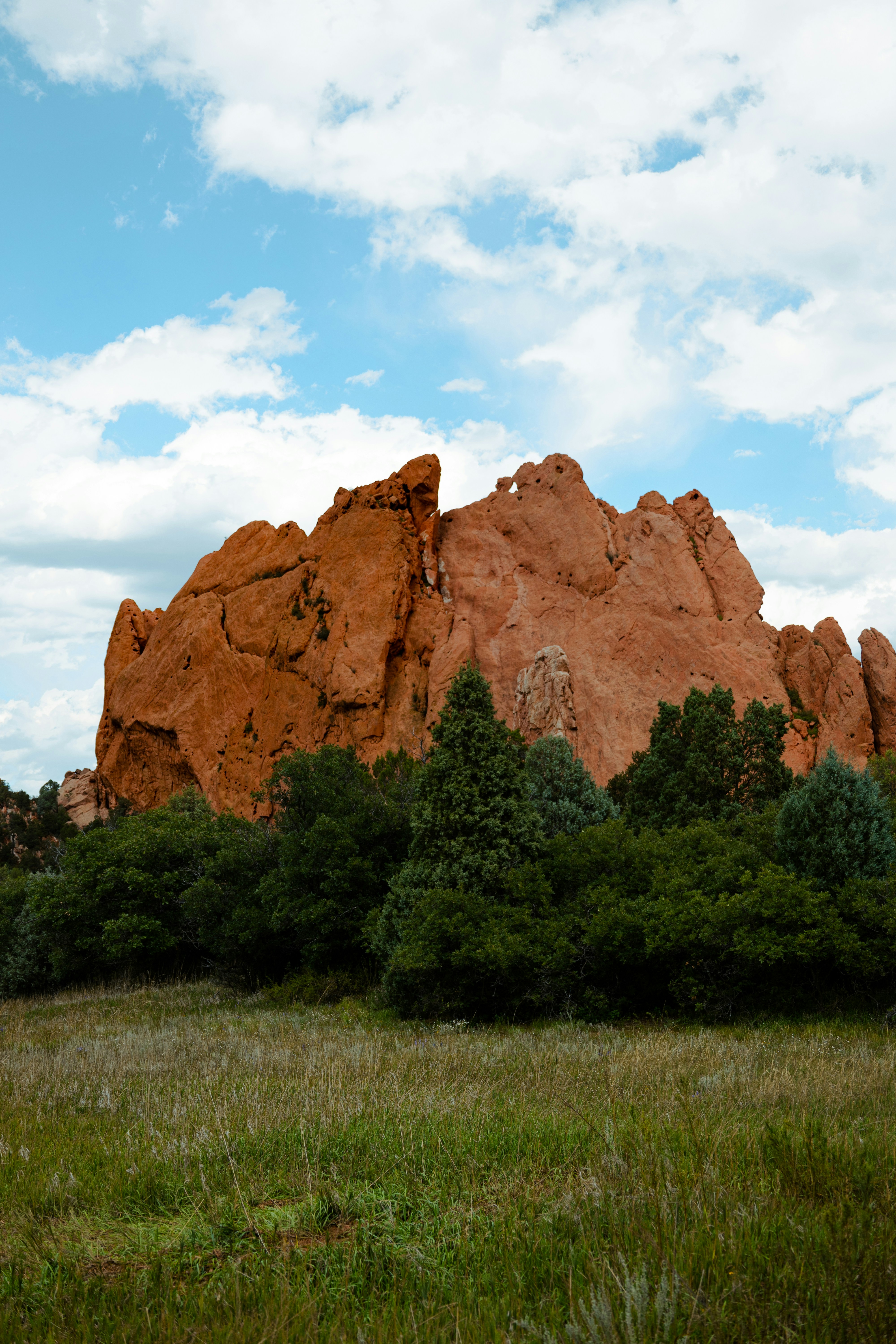 A large rock formation in the middle of a field