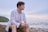 A man sitting on a rock near the ocean